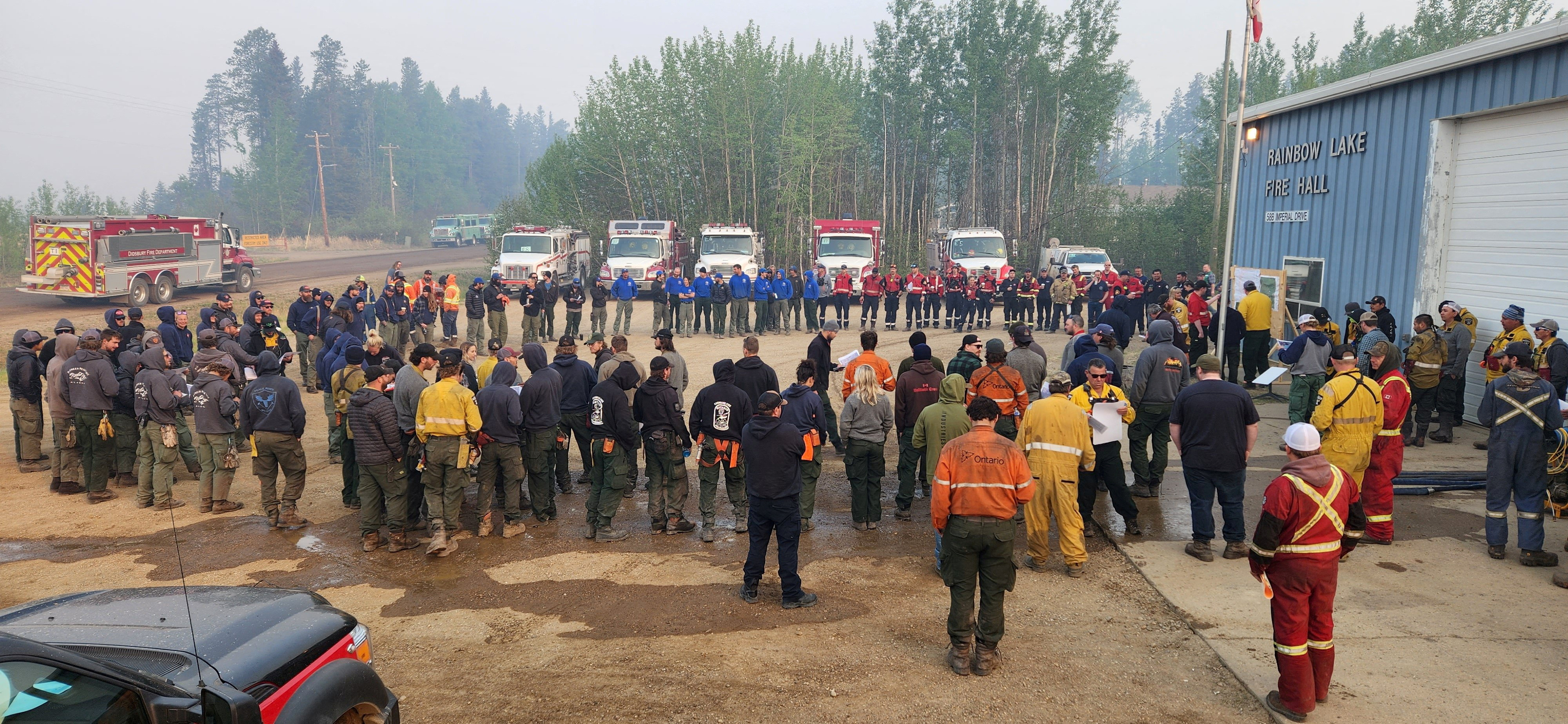 Firefighters gather for a morning briefing at Rainbow Lake Fire Hall