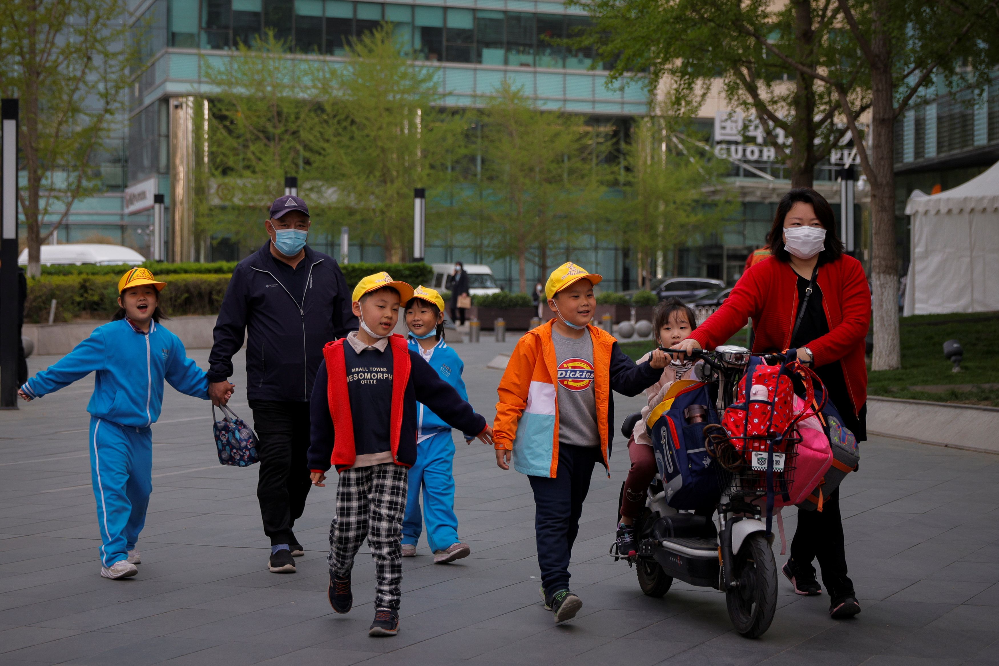 People pick up children from a school in Beijing