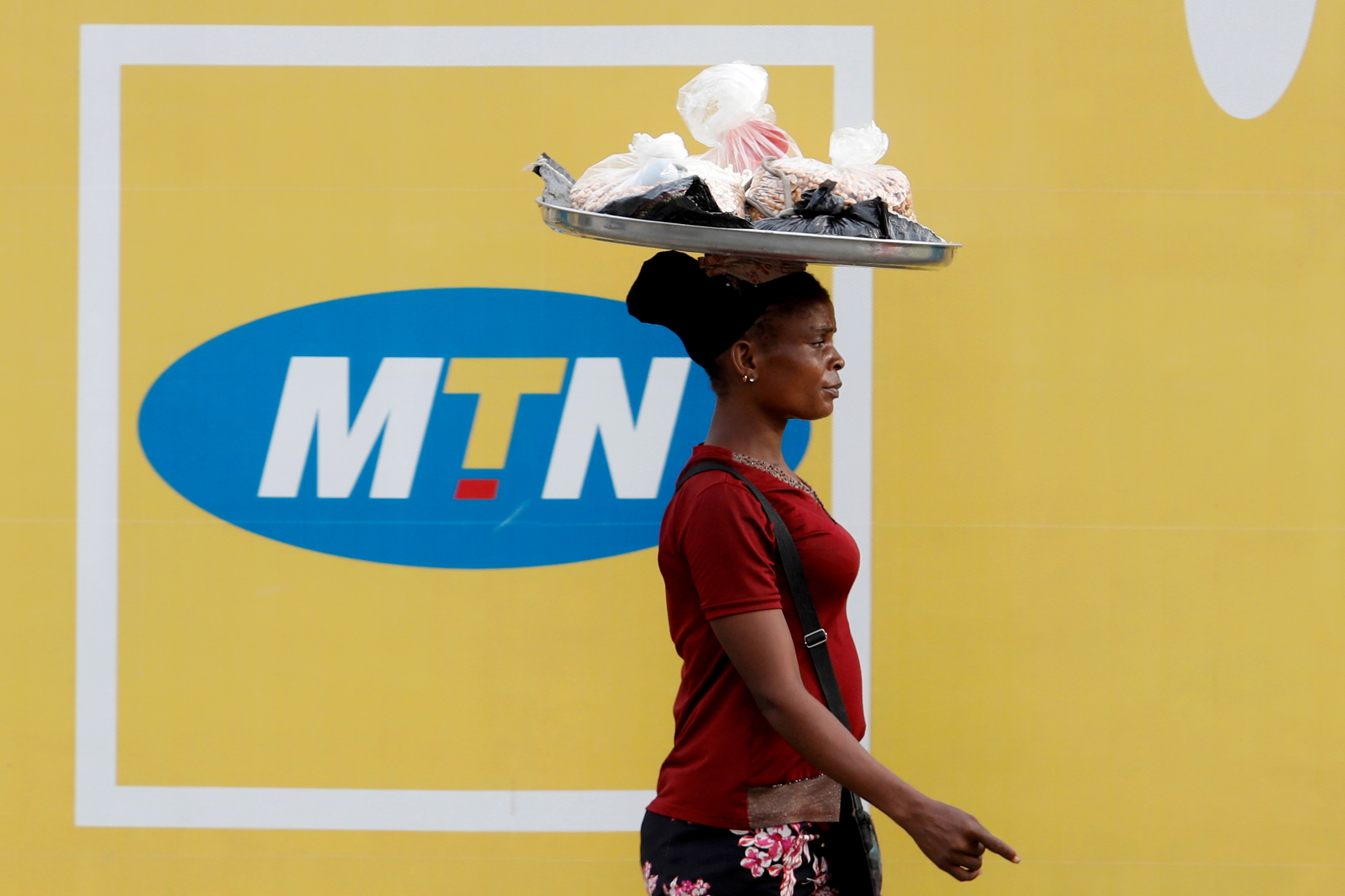   A woman walks past an advertising posters for MTN telecommunication company along a street in Lagos, Nigeria August 28, 2019. REUTERS/Temilade Adelaja/File Photo