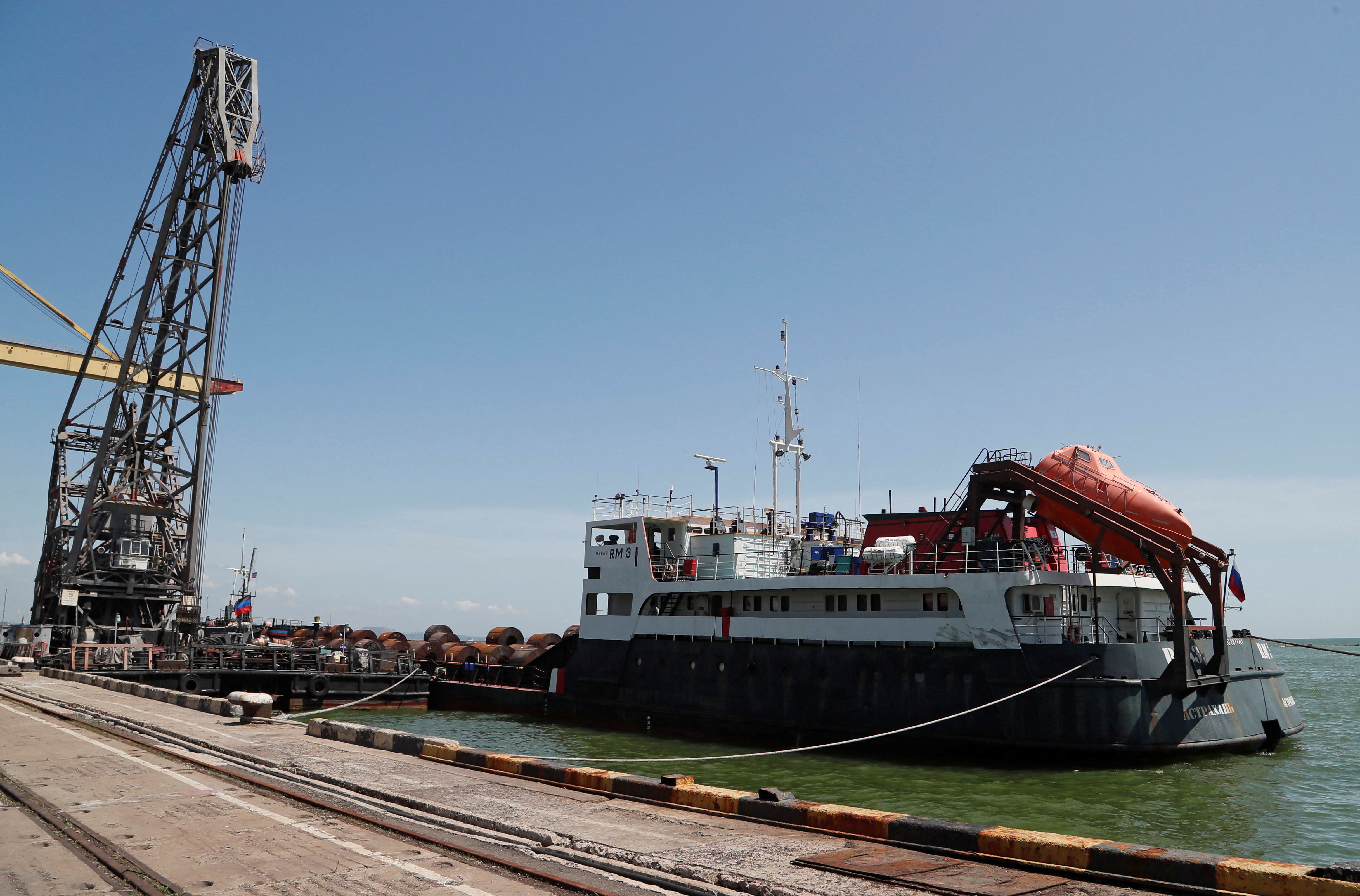 A cargo ship is loaded with steel rolls at the Port of Mariupol