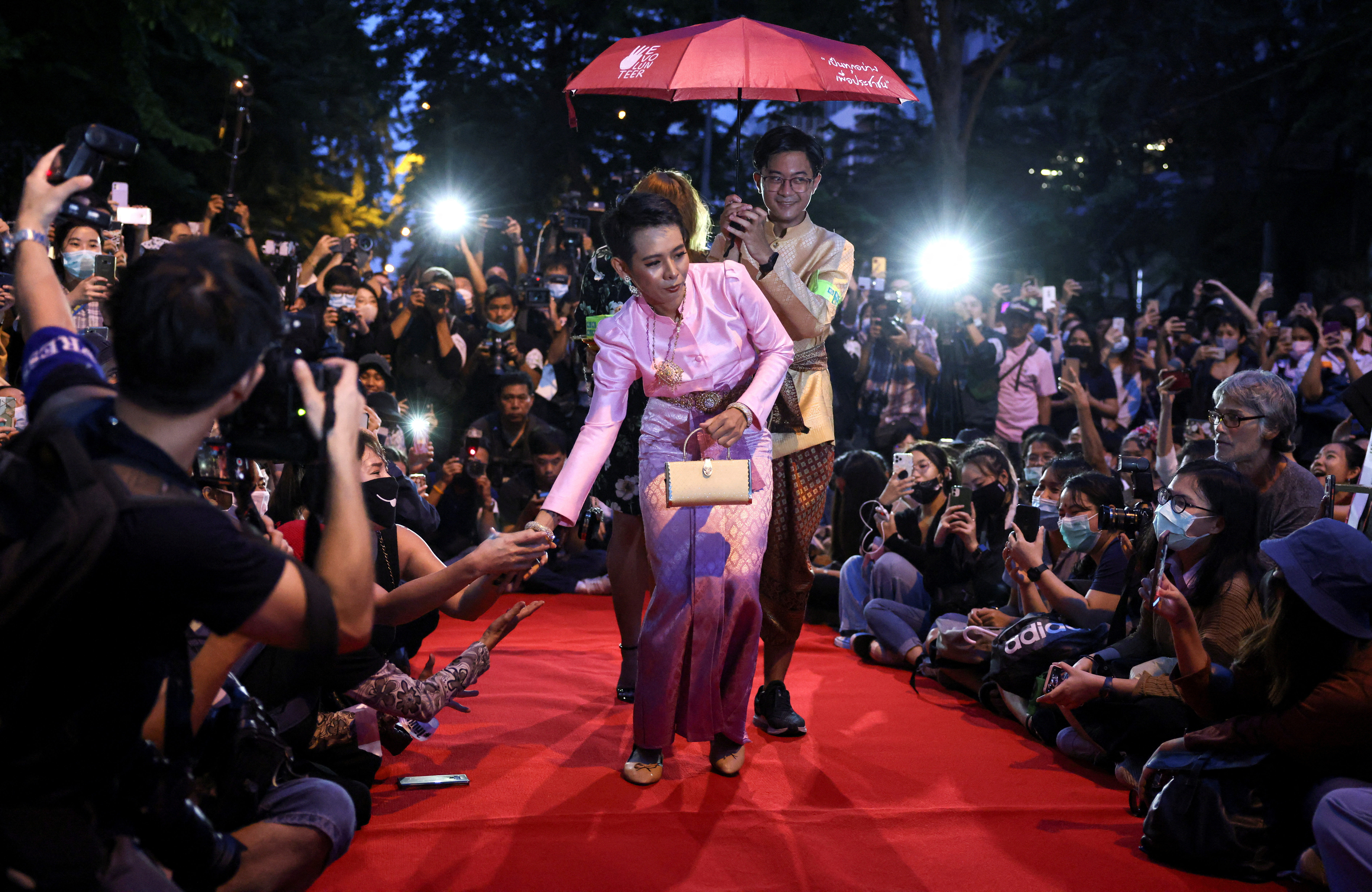Protesters perform on a red carpet while taking part in a protest against the government and to reform monarchy in Bangkok