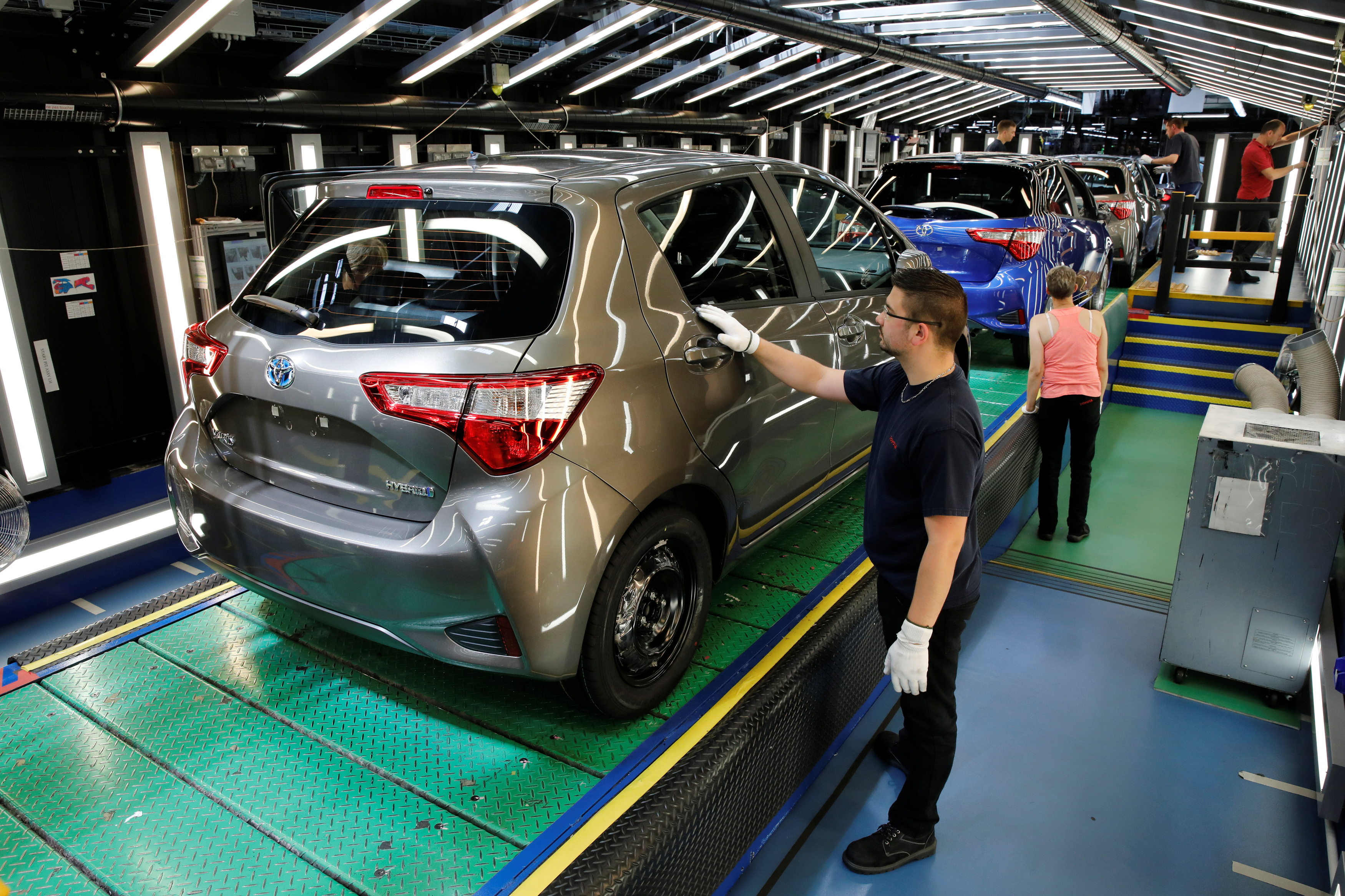 A Toyota Motor Corp. worker inspects a Yaris on the production line of the company's plant in Onnaing, near Valenciennes