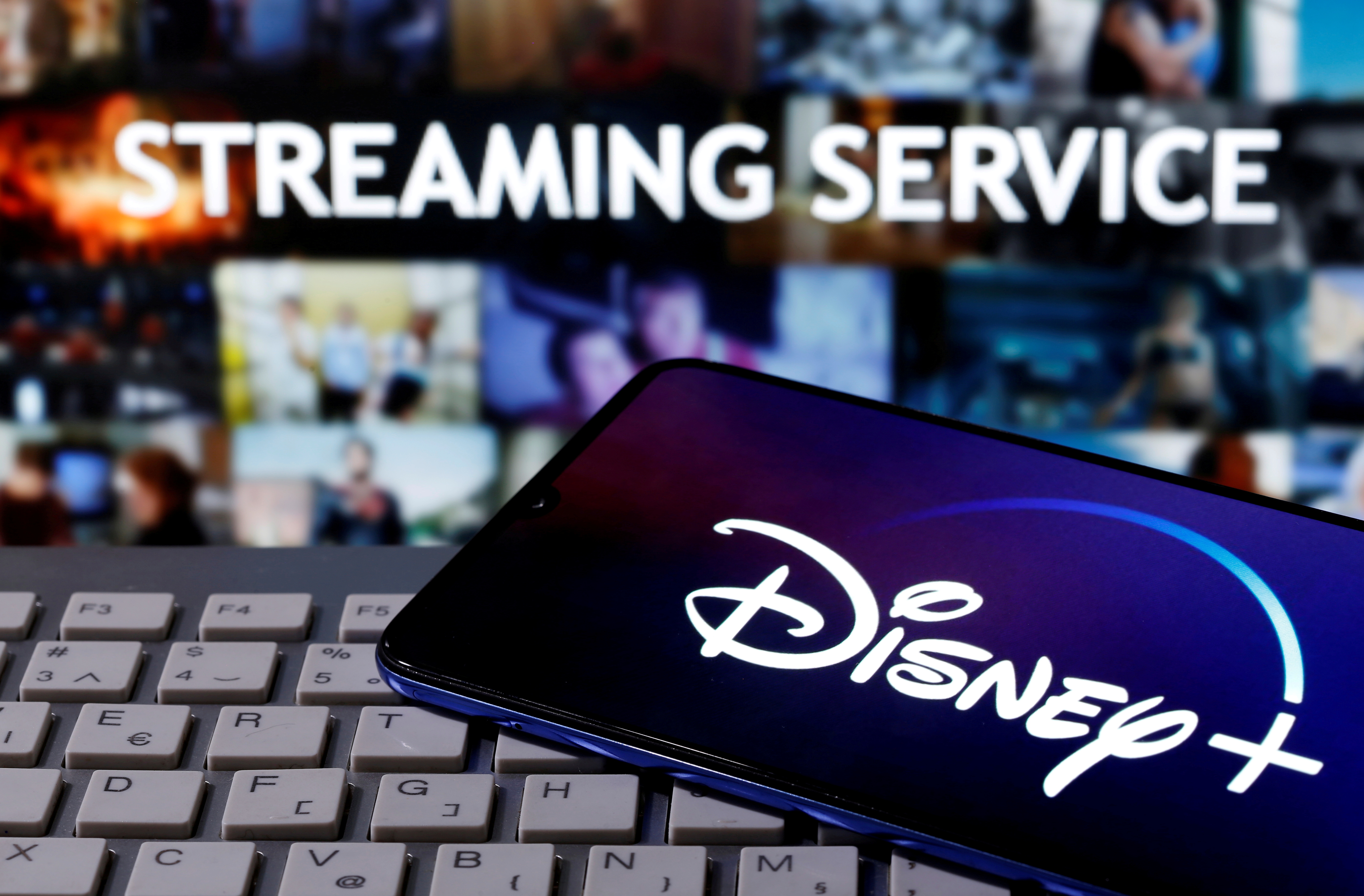 FILE PHOTO: Smartphone with the "Disney" logo is seen on a keyboard in front of the words "Streaming service\