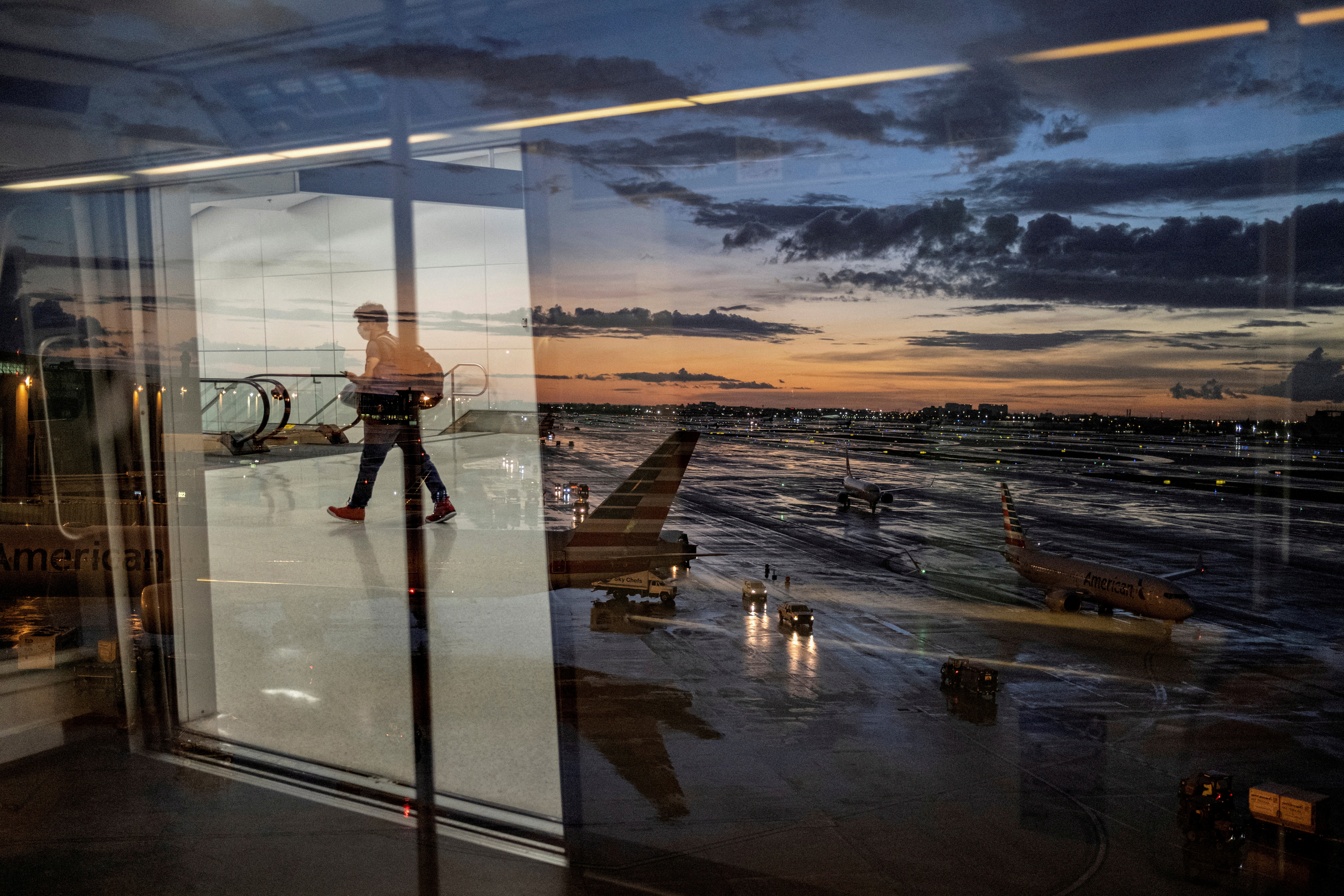 A passenger arrives at the airport as Hurricane Elsa moves towards south Florida, in Miami