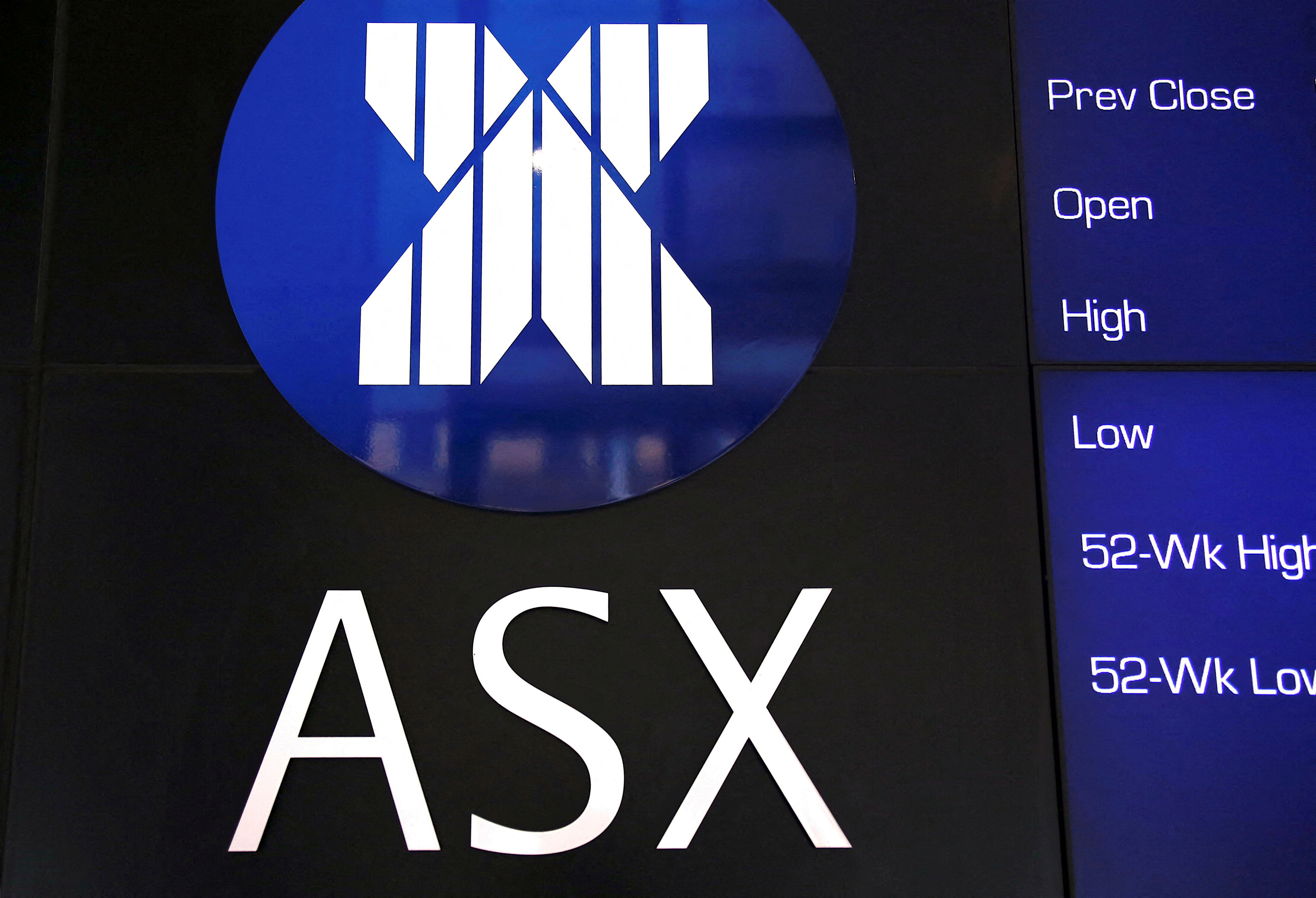 A board displaying stock prices is adorned with the Australian Securities Exchange (ASX) logo in central Sydney