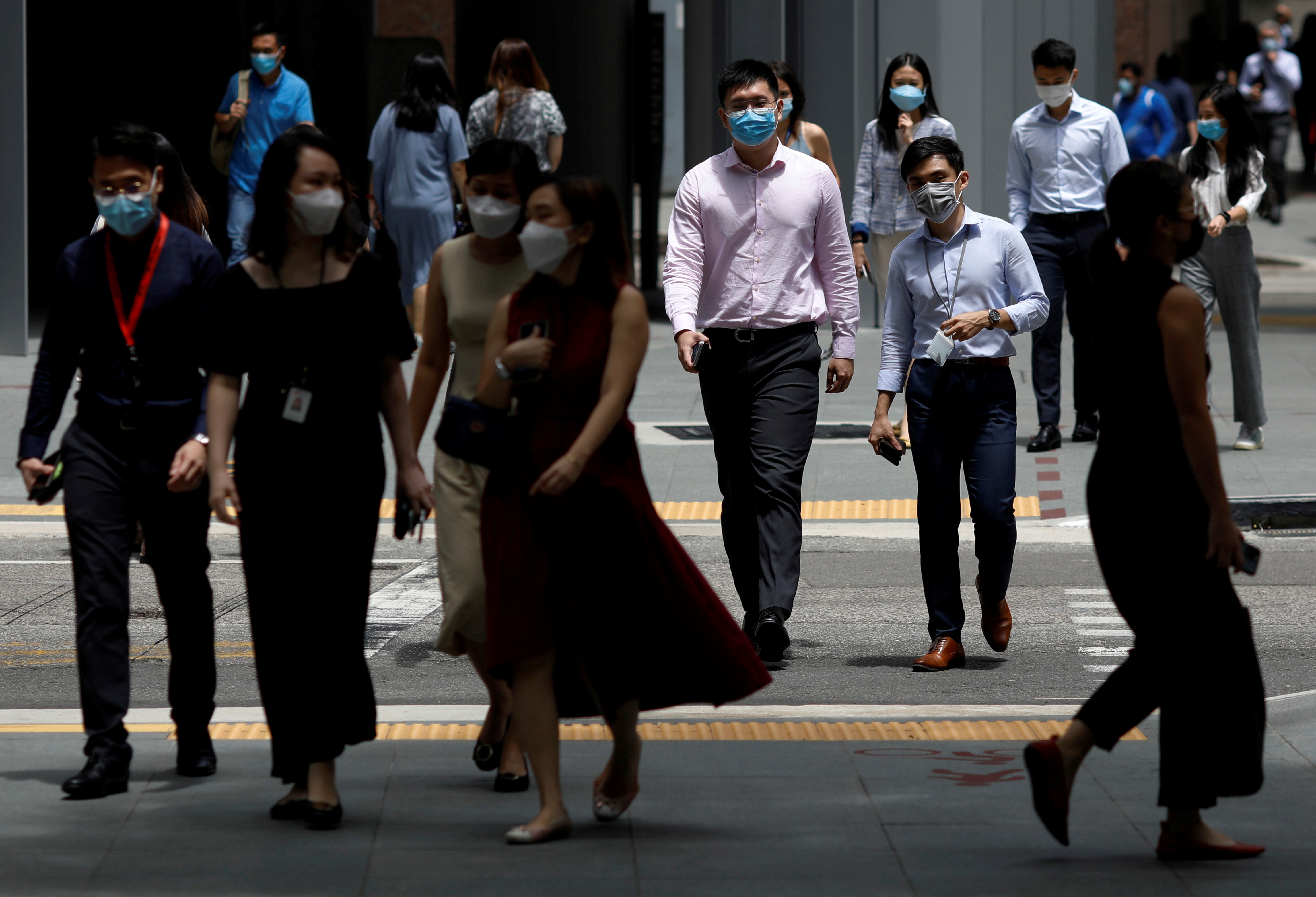 Office workers spend their lunch breaks at the central business district during the COVID-19 outbreak in Singapore