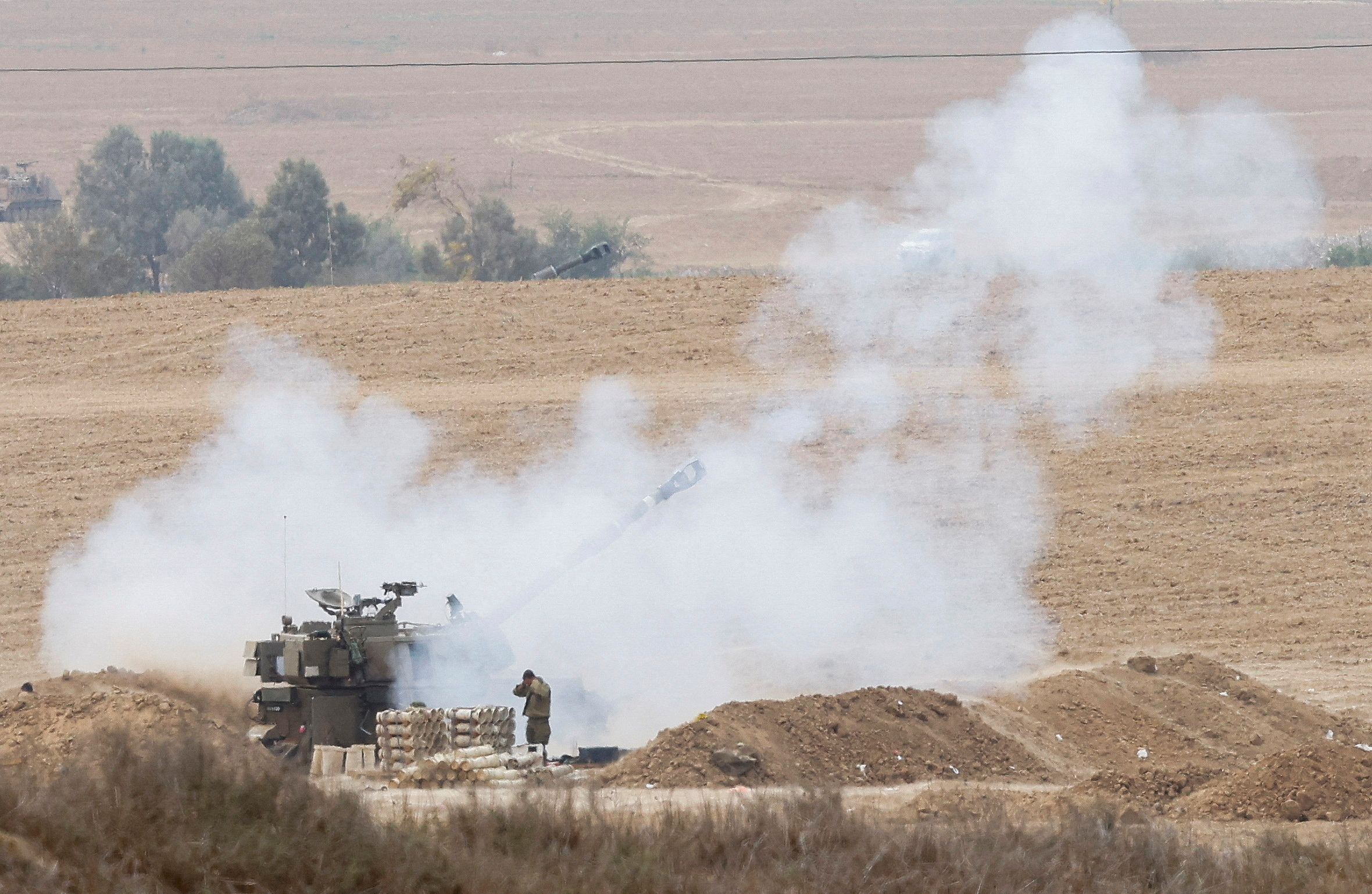 Israeli artillery unit fires from the Israeli side of the Israel-Gaza border into Gaza
