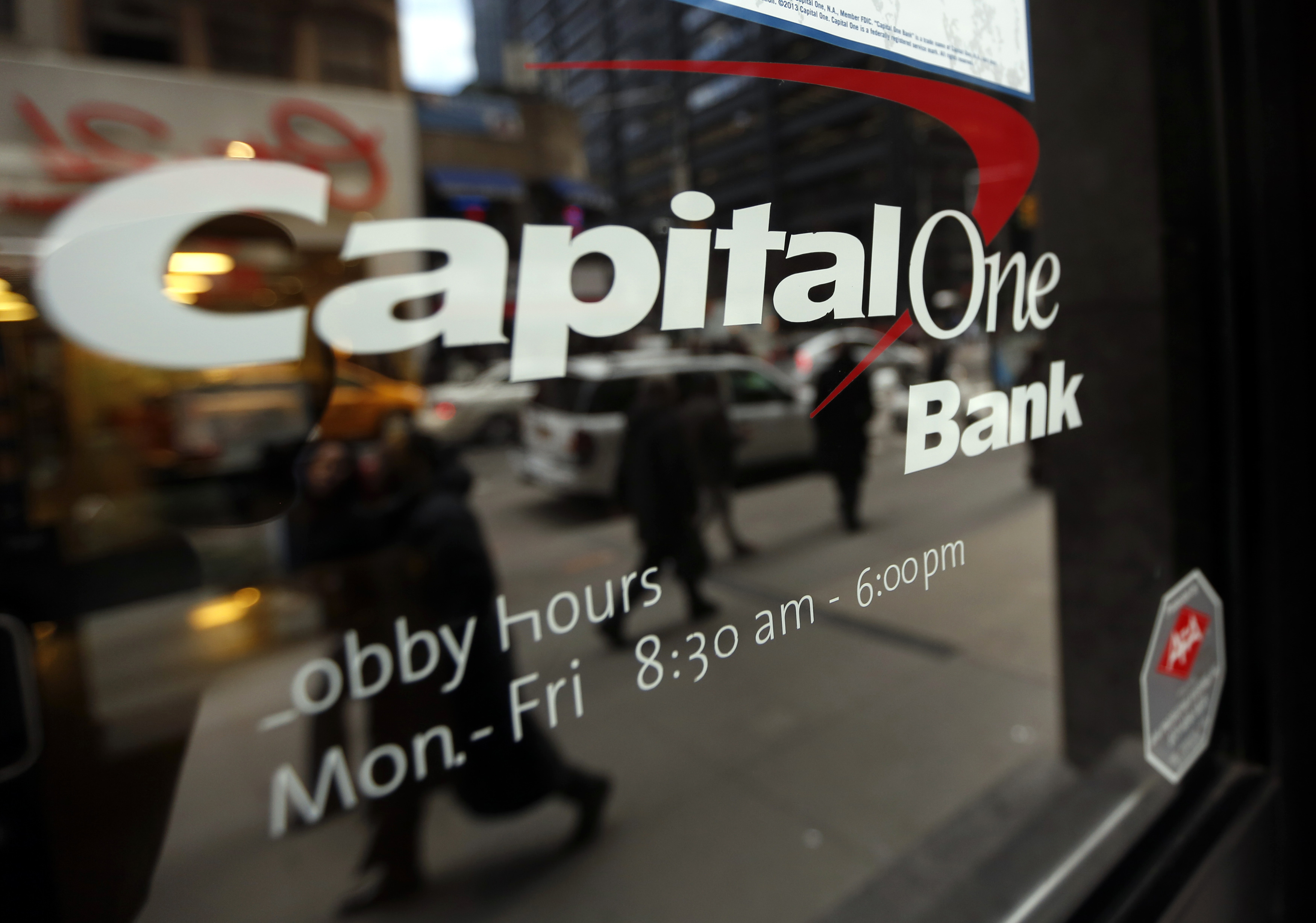 People walk past a Capital One banking center in New York's financial district. REUTERS/Brendan McDermid 