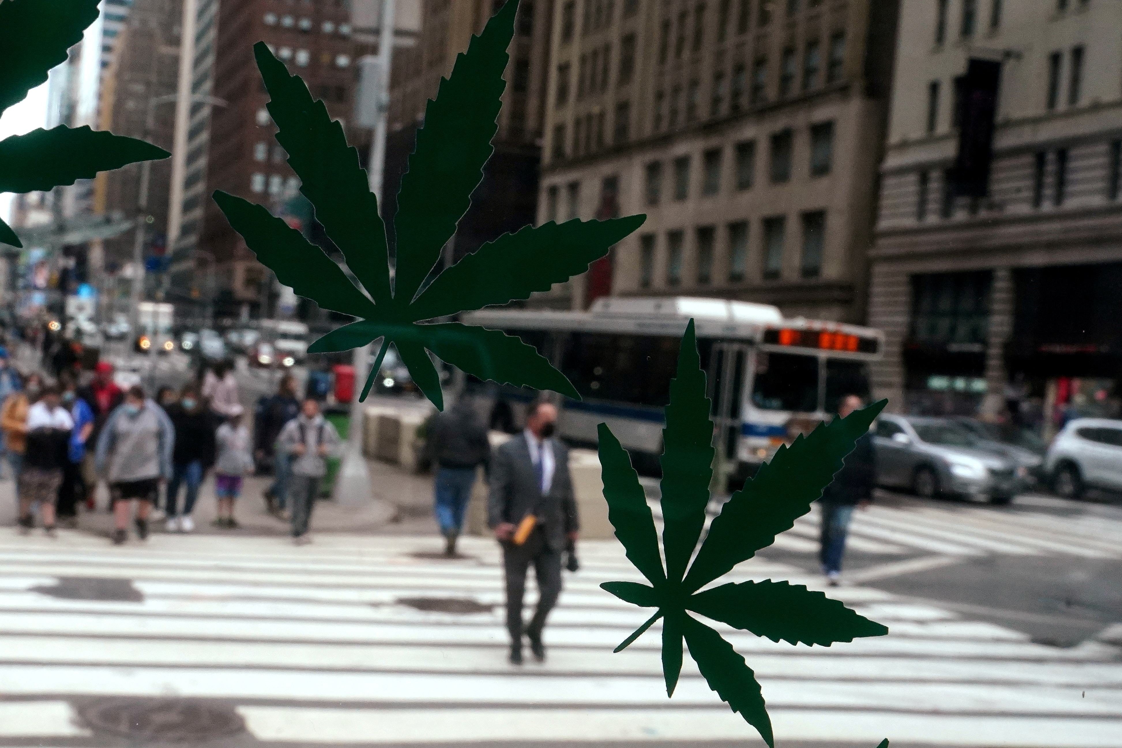 Cannabis stickers on a Weed World store window are pictured the day New York State legalized recreational marijuana use in New York City