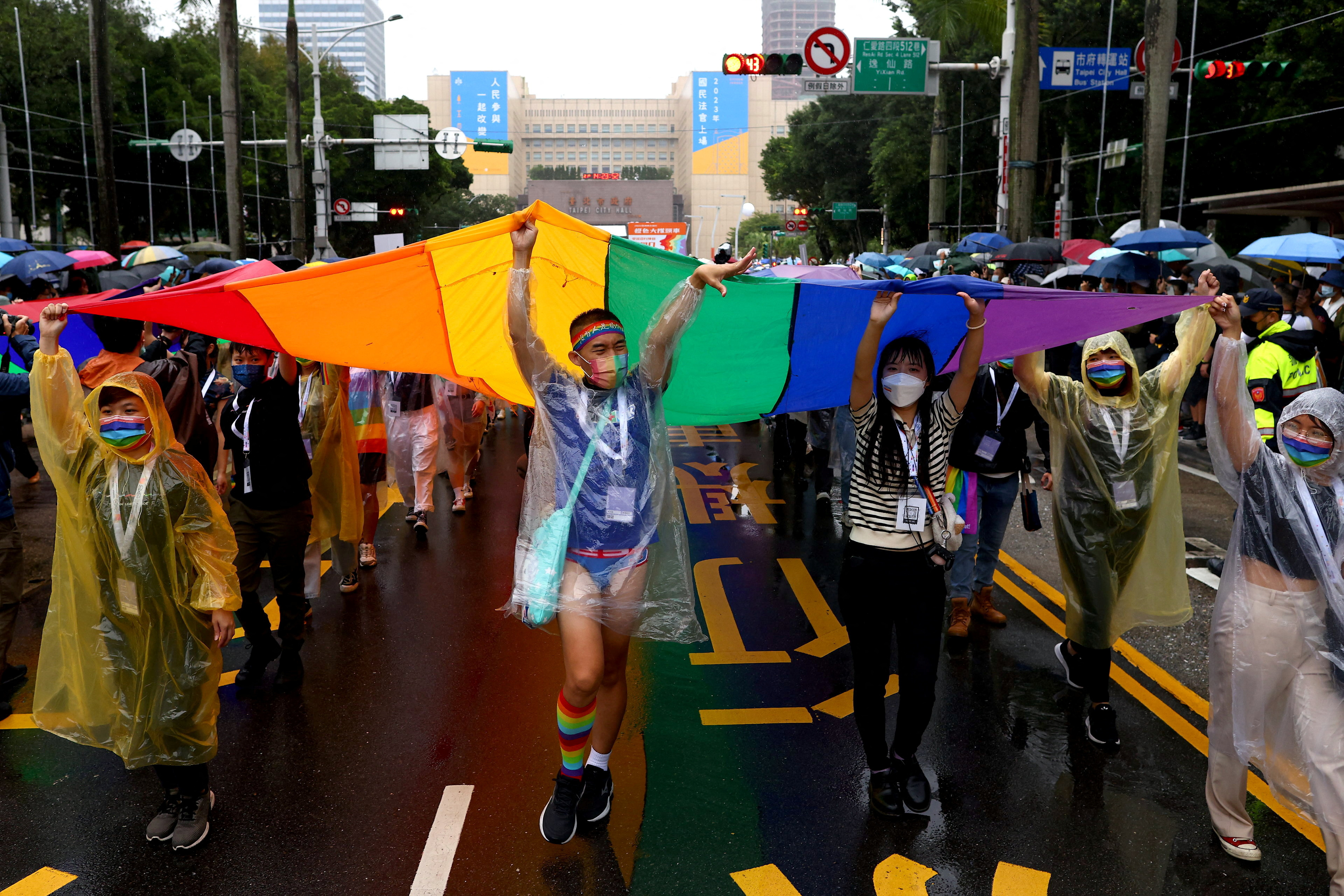 People hold a giant rainbow flag during the pride parade in Taipei