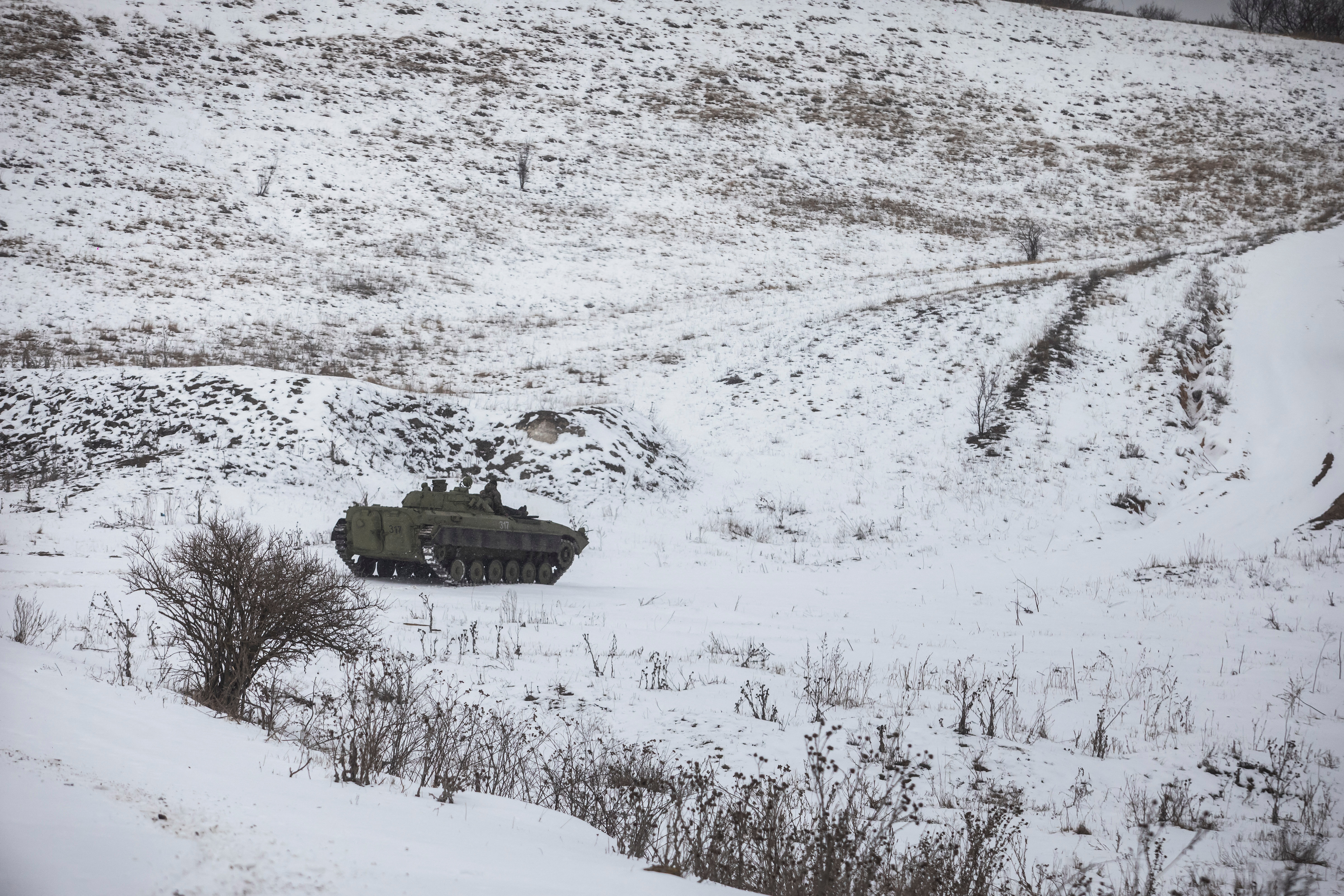 Ukrainian serviceman rides atop of a BPM-1 infantry fighting vehicle in the frontline town of Bakhmut