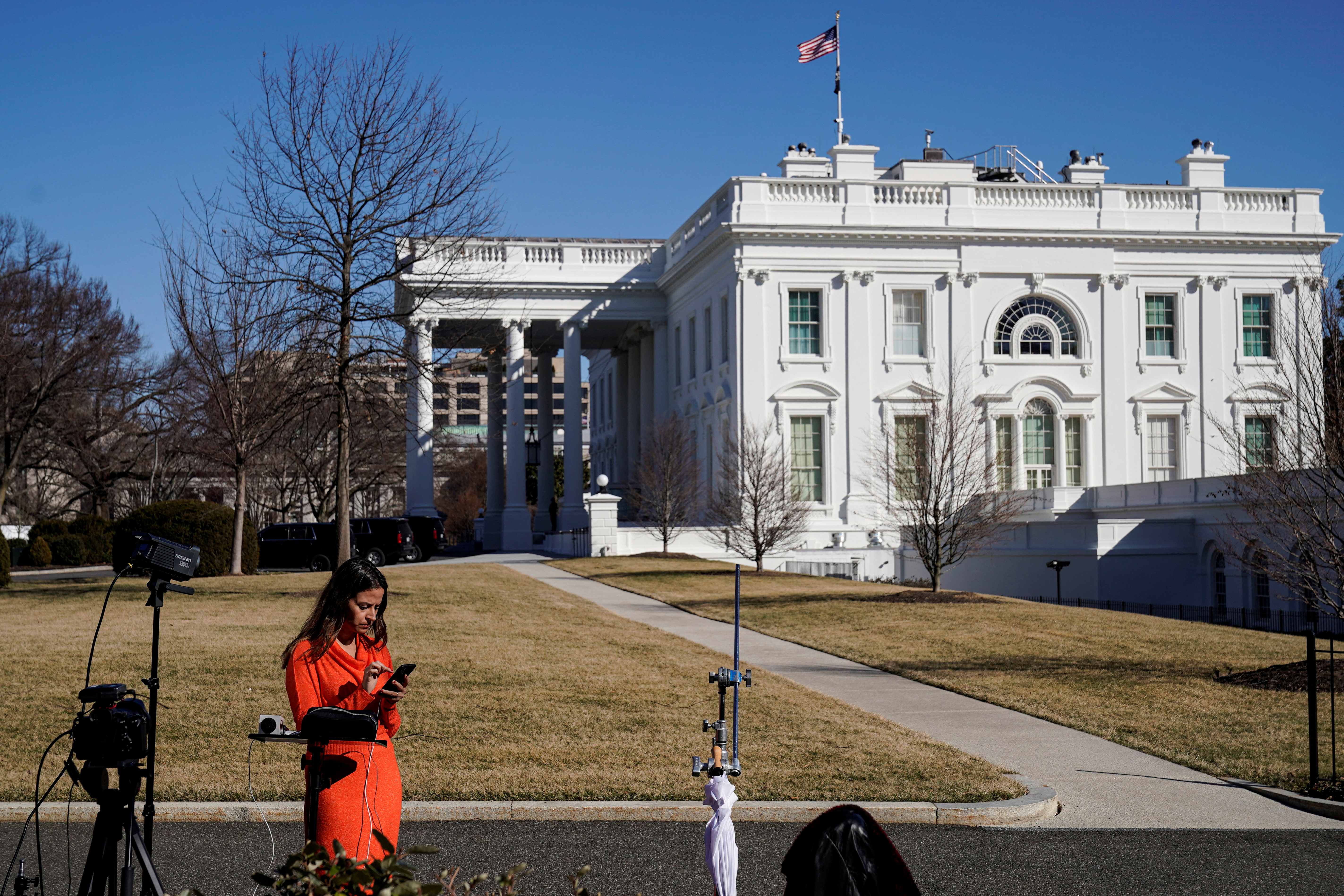 Journalists report on the ongoing situation in Ukraine at the White House in Washington