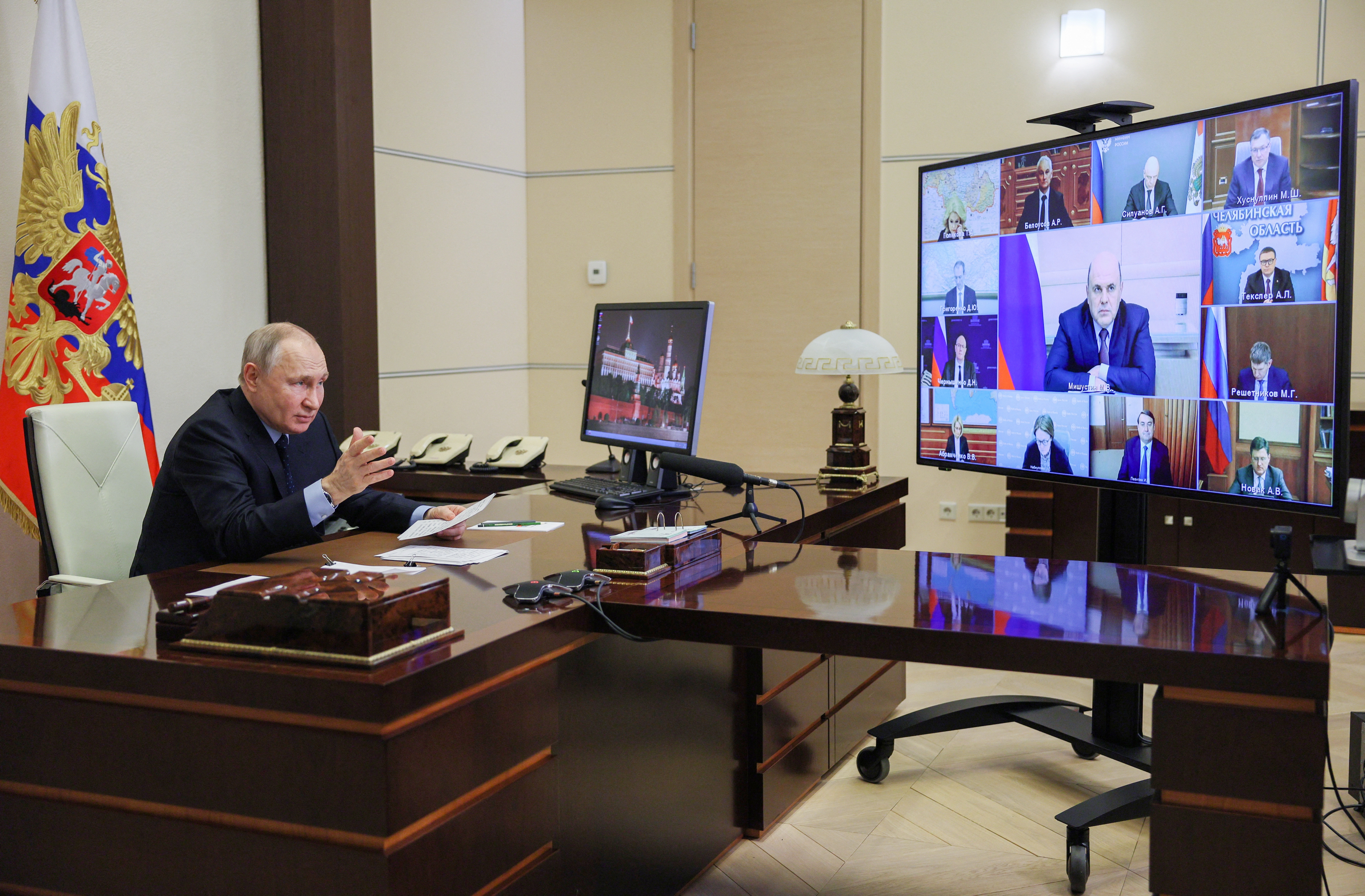 Russian President Vladimir Putin chairs a meeting with members of the government, via video link outside Moscow