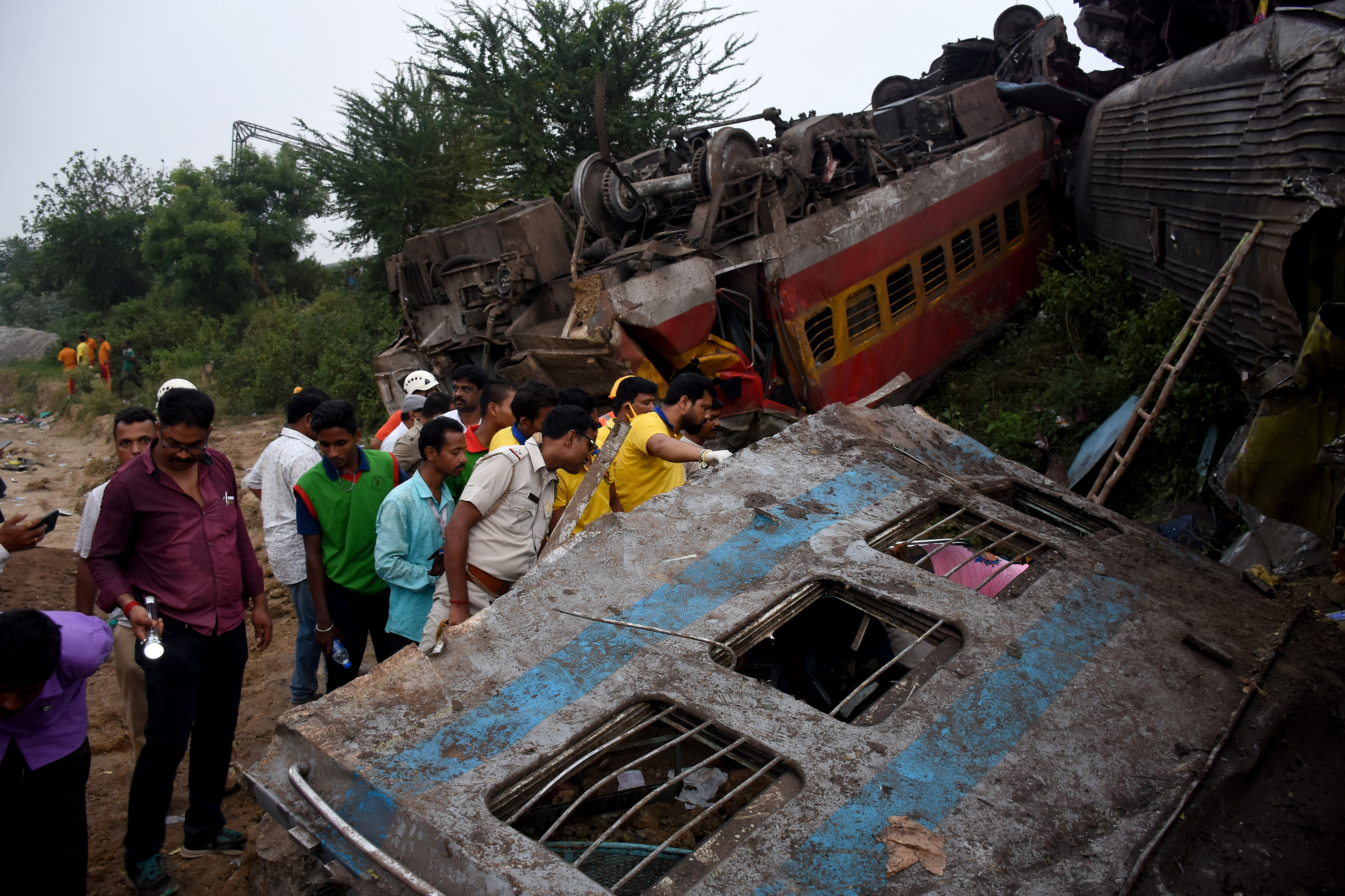 Rescue workers search for survivors after two passenger trains collided in Balasore
