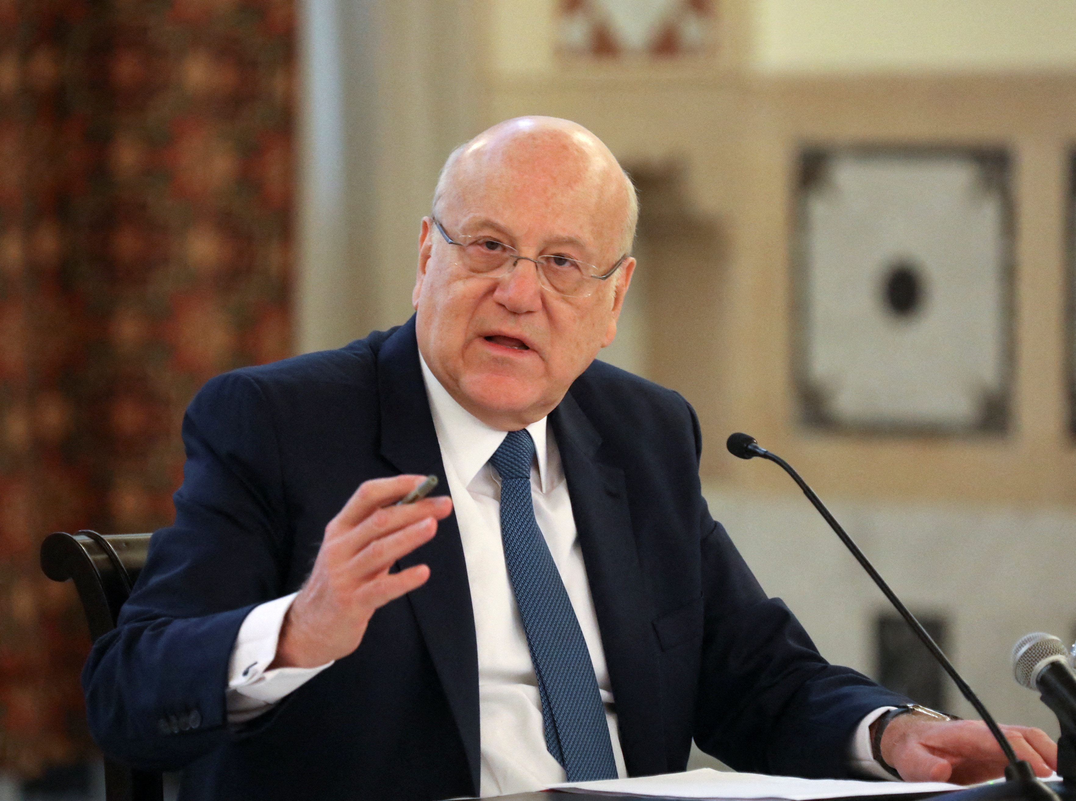 Lebanese Prime Minister Najib Mikati gestures during a news conference on the latest developments in the country, at the governmental palace in Beirut