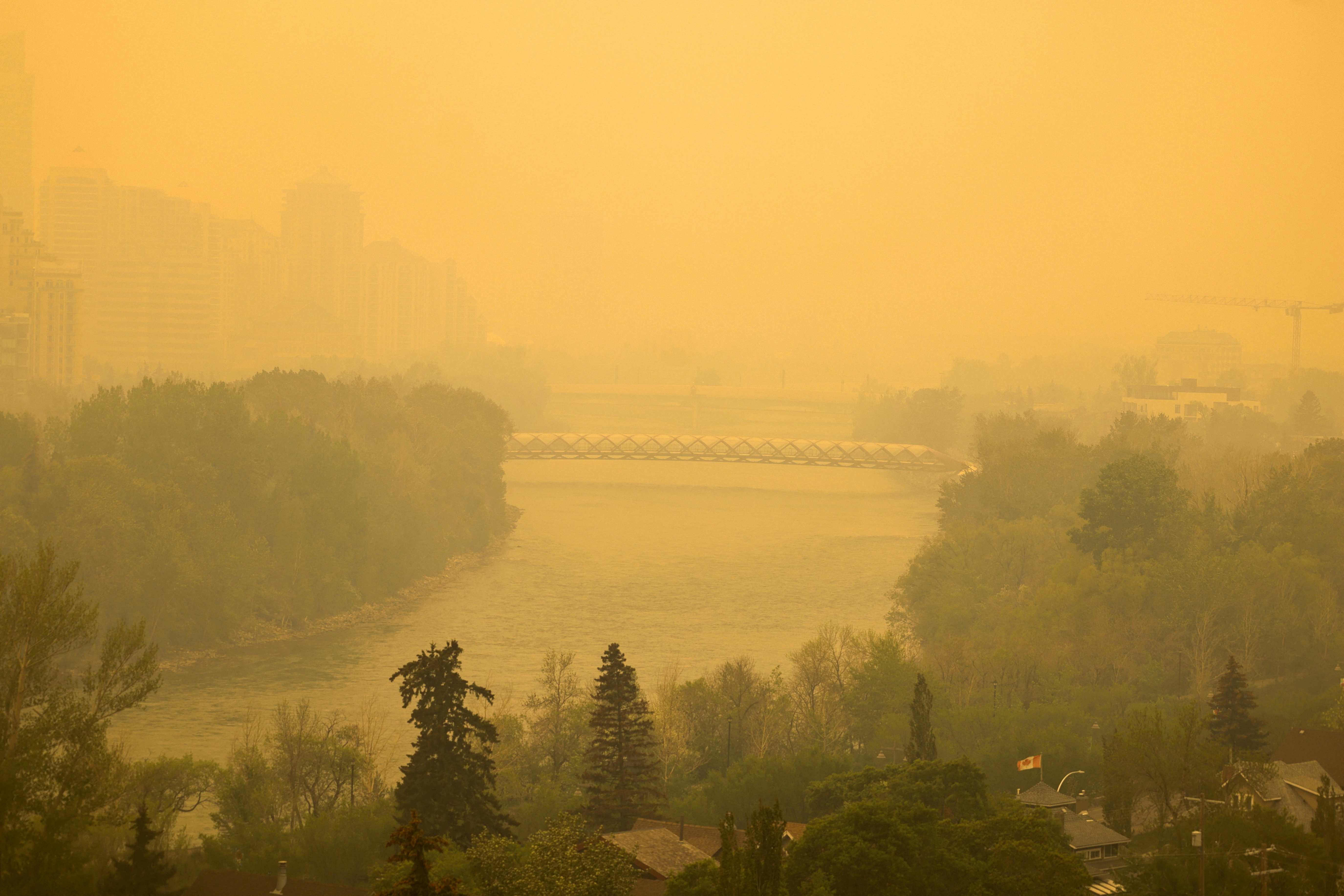 Smoke from some of the 90 wildfires active in the province hangs in downtown Calgary