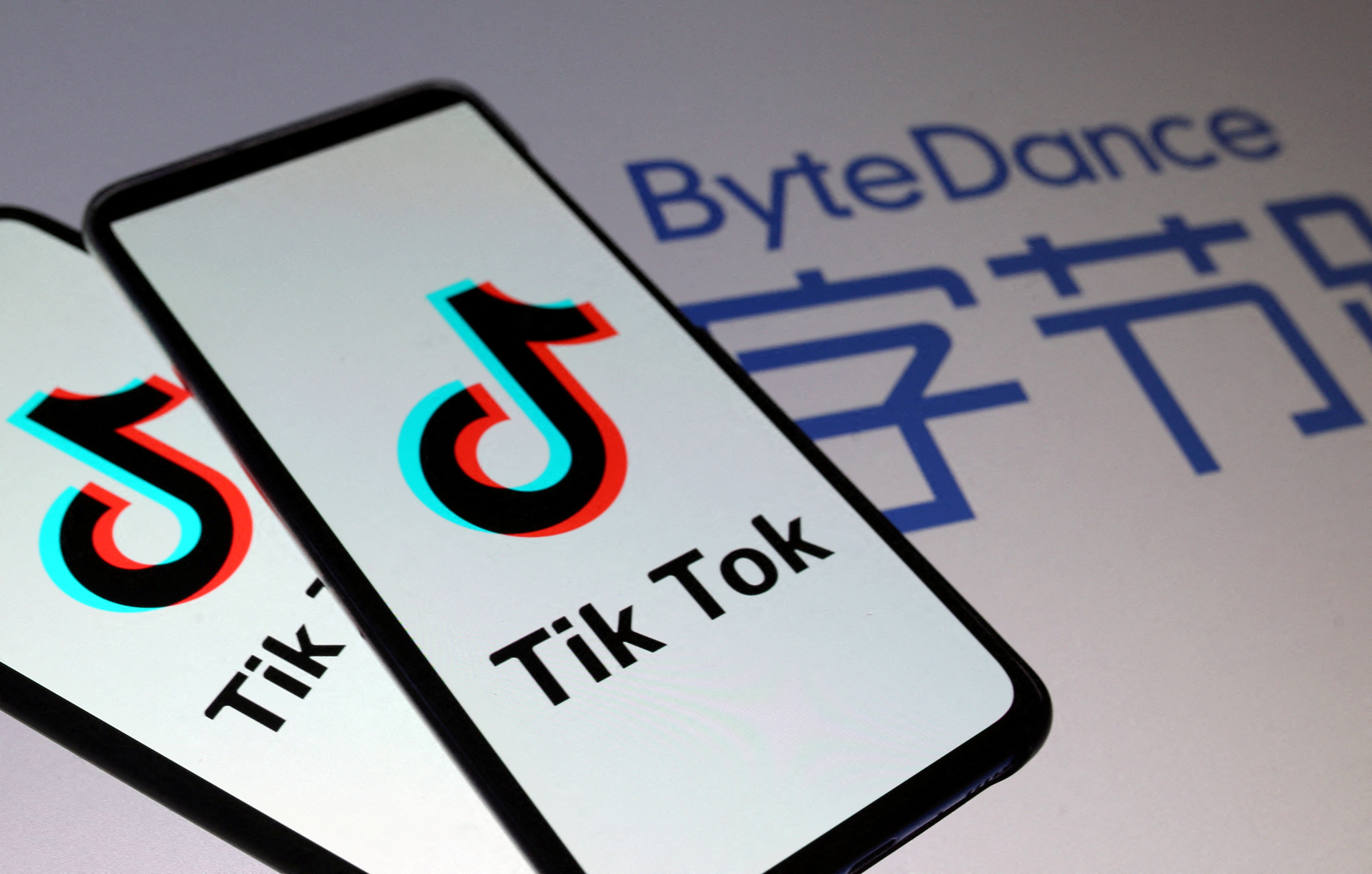 Tik Tok logos are seen on smartphones in front of a displayed ByteDance logo in this illustration taken November 27, 2019. REUTERS/Dado Ruvic/Illustration/File Photo