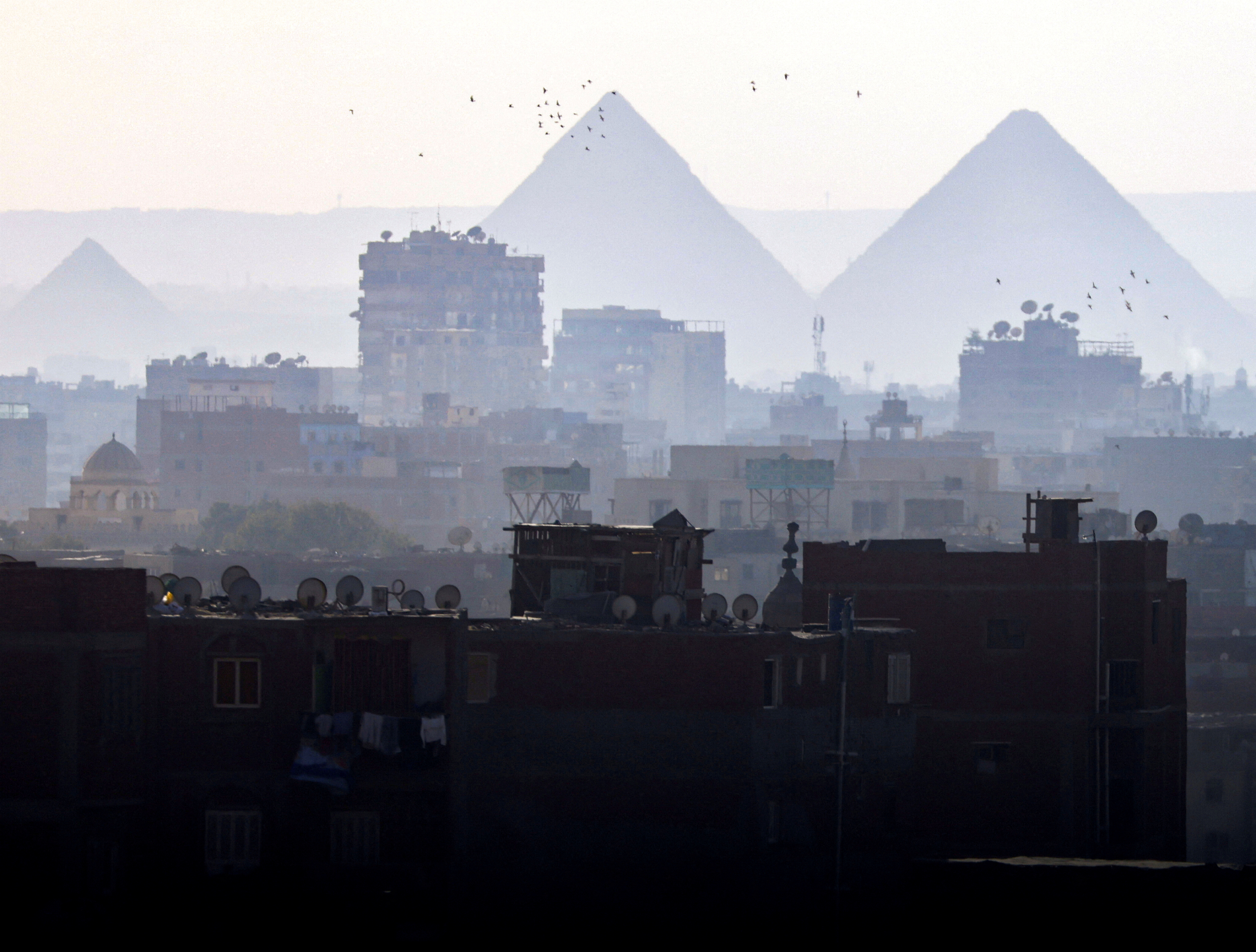 A general view of fog over the Great Pyramids and old houses in Cairo