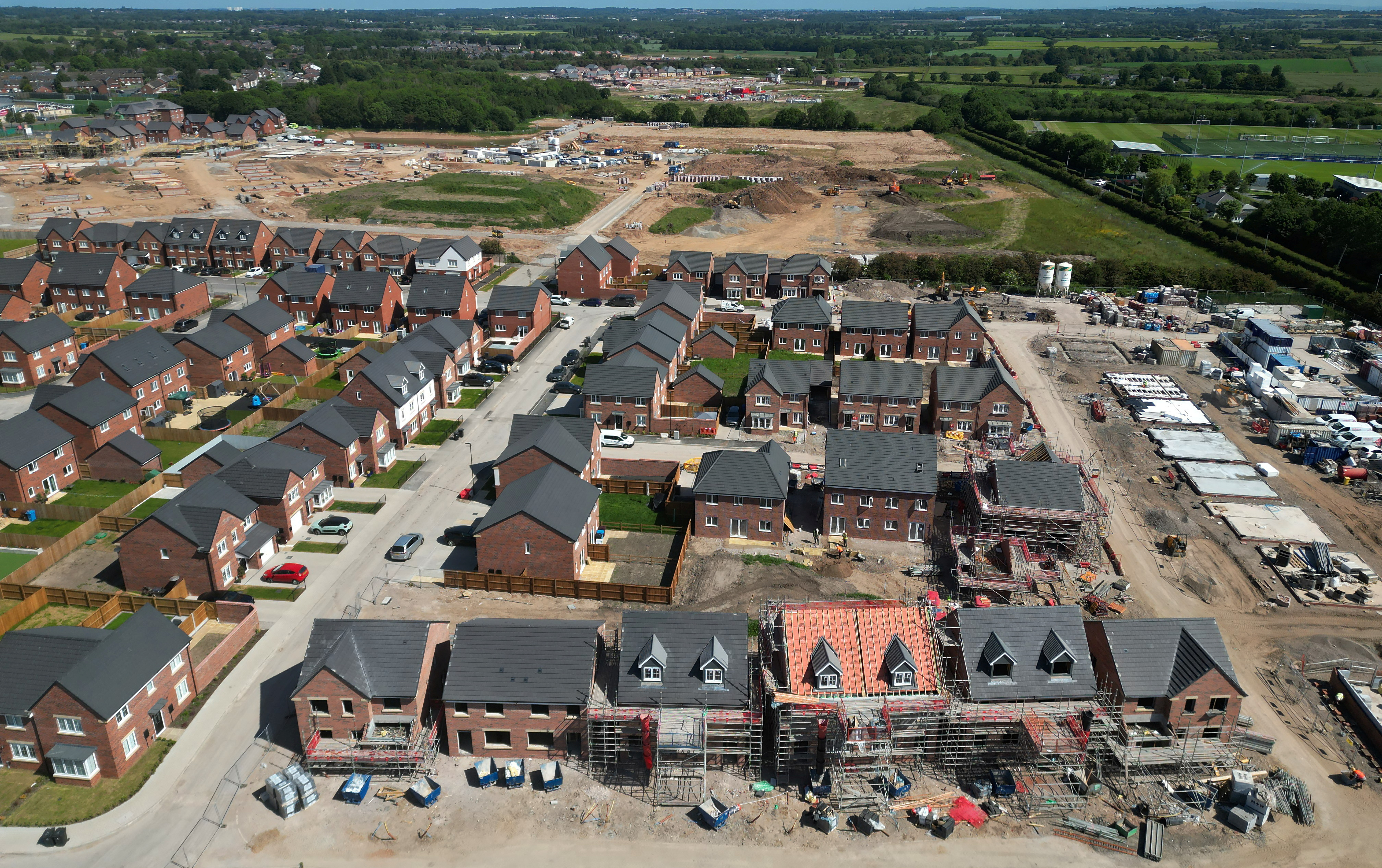Partly finished houses are seen on a new housing development under construction in Liverpool, Britain