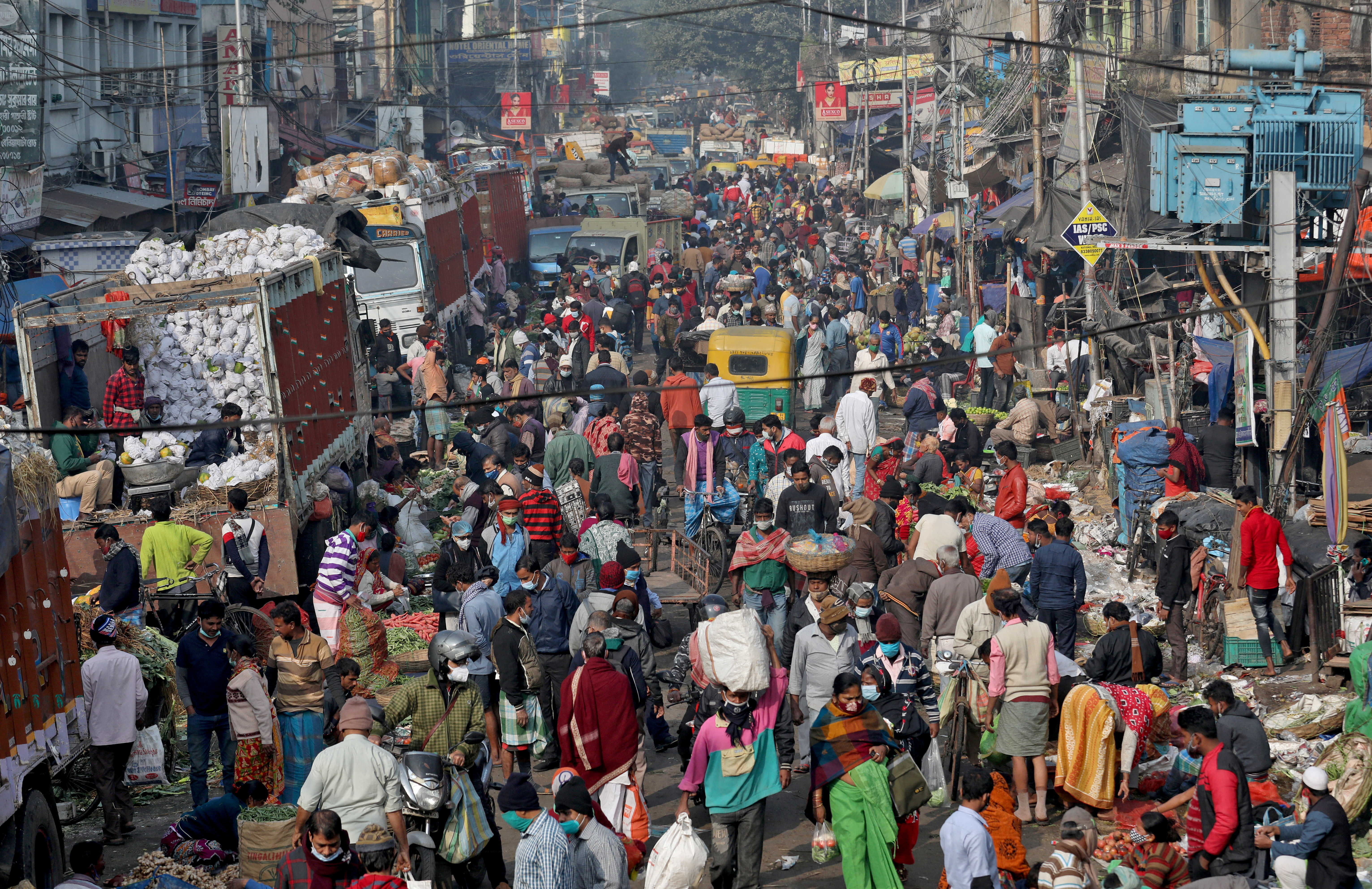 People shop in a crowded market amidst the spread of the coronavirus disease (COVID-19), in Kolkata