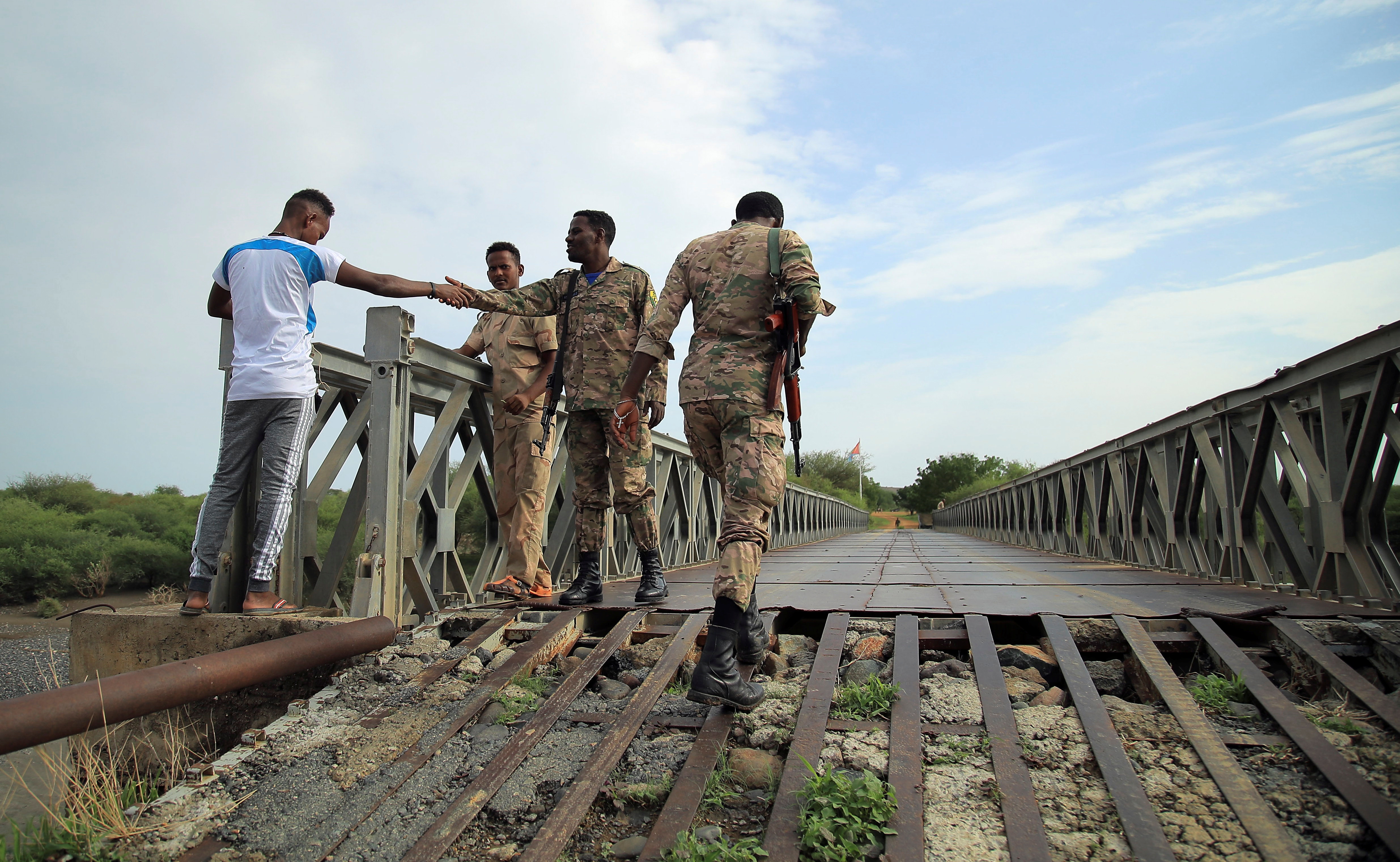 Members of Amhara Special Forces greet Eritrean Defence Forces on the Tekeze river bridge near Ethiopia-Eritrean border