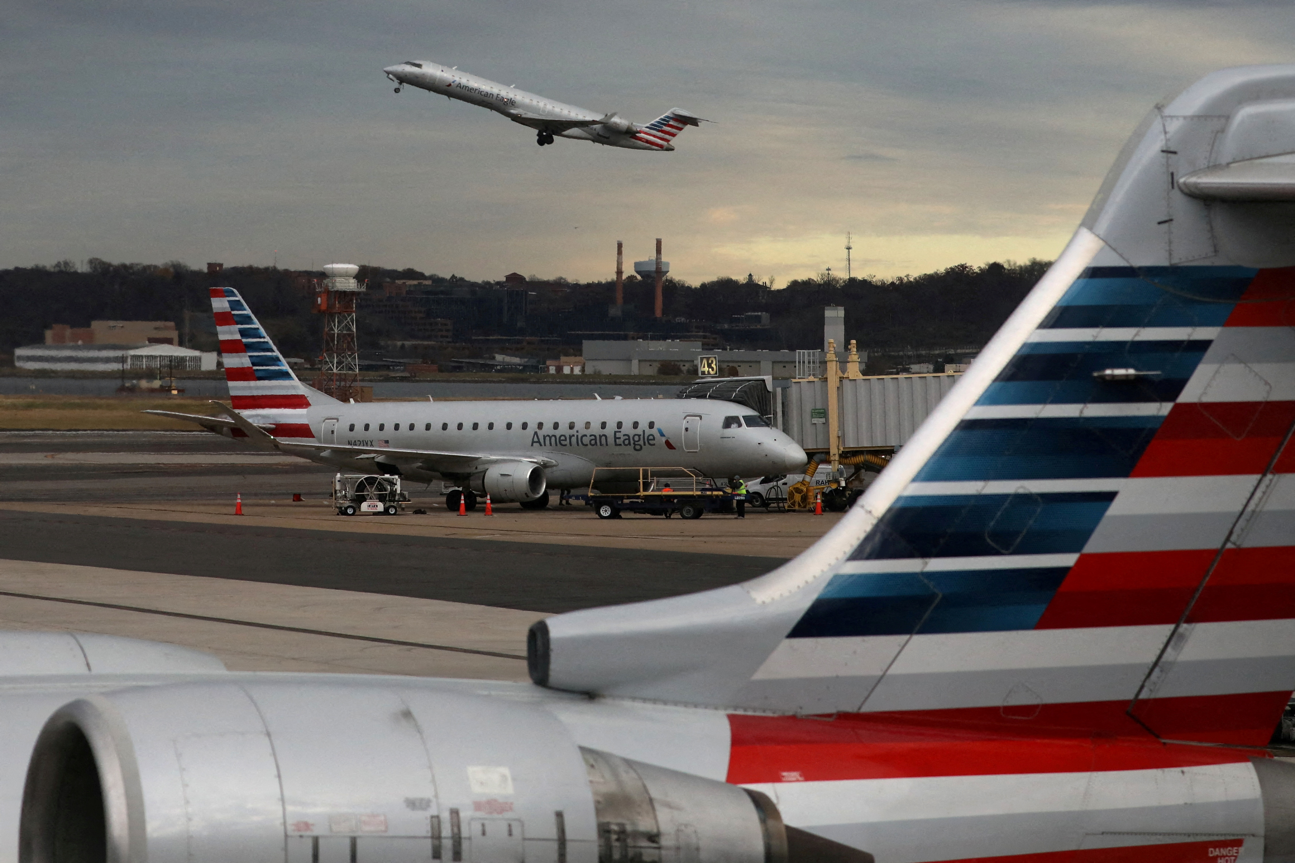 A jet from American Eagle, a regional branch of American Airlines (AA), takes off past other AA aircraft at Ronald Reagan Washington National Airport in Arlington