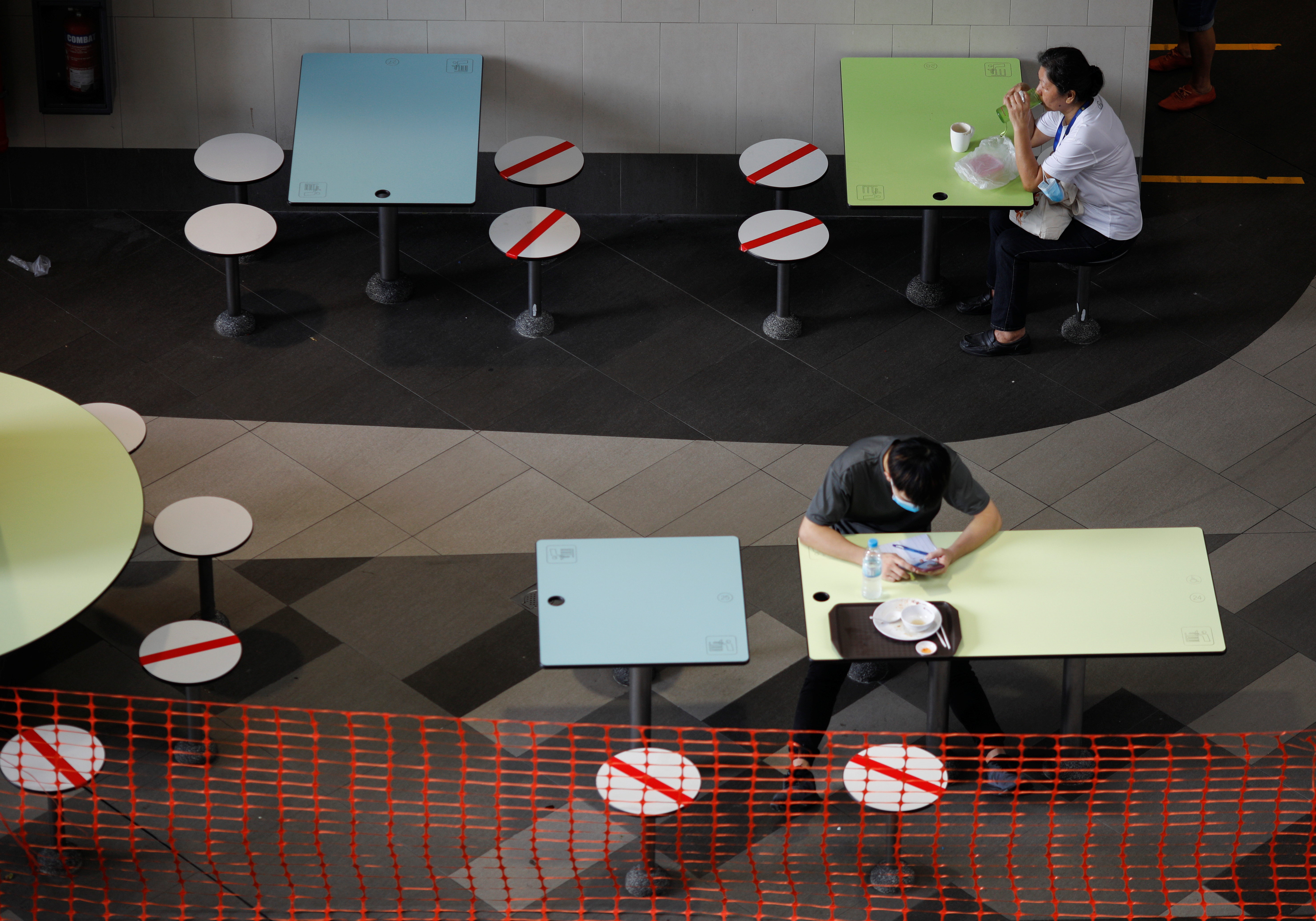 People dine at a food center during the coronavirus disease (COVID-19) outbreak, in Singapore