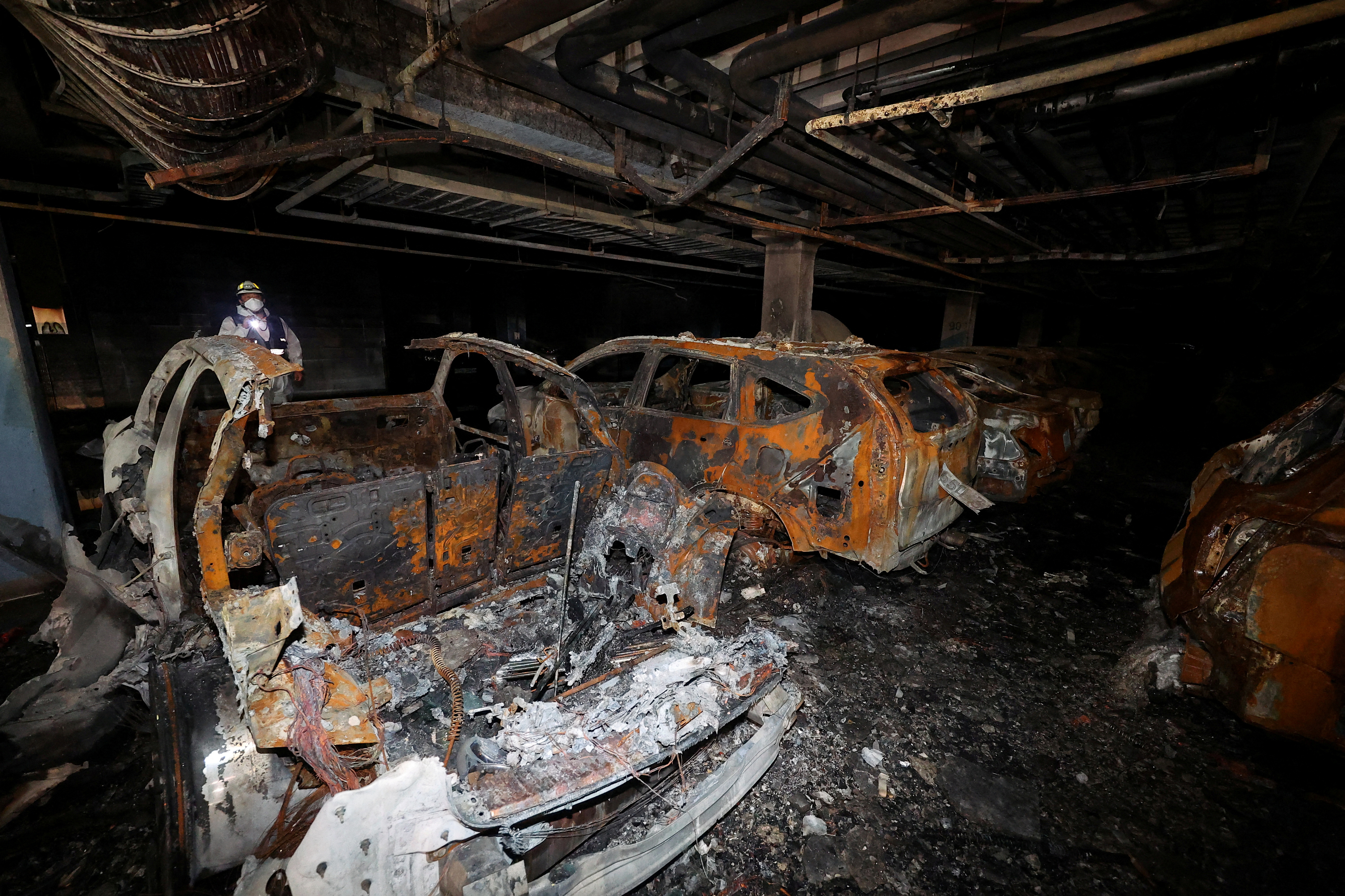 Vehicles that were completely burned down due to a Mercedes Benz electric car fire that broke out on August 1st, are lying in the underground parking lot of an apartment complex in Incheon