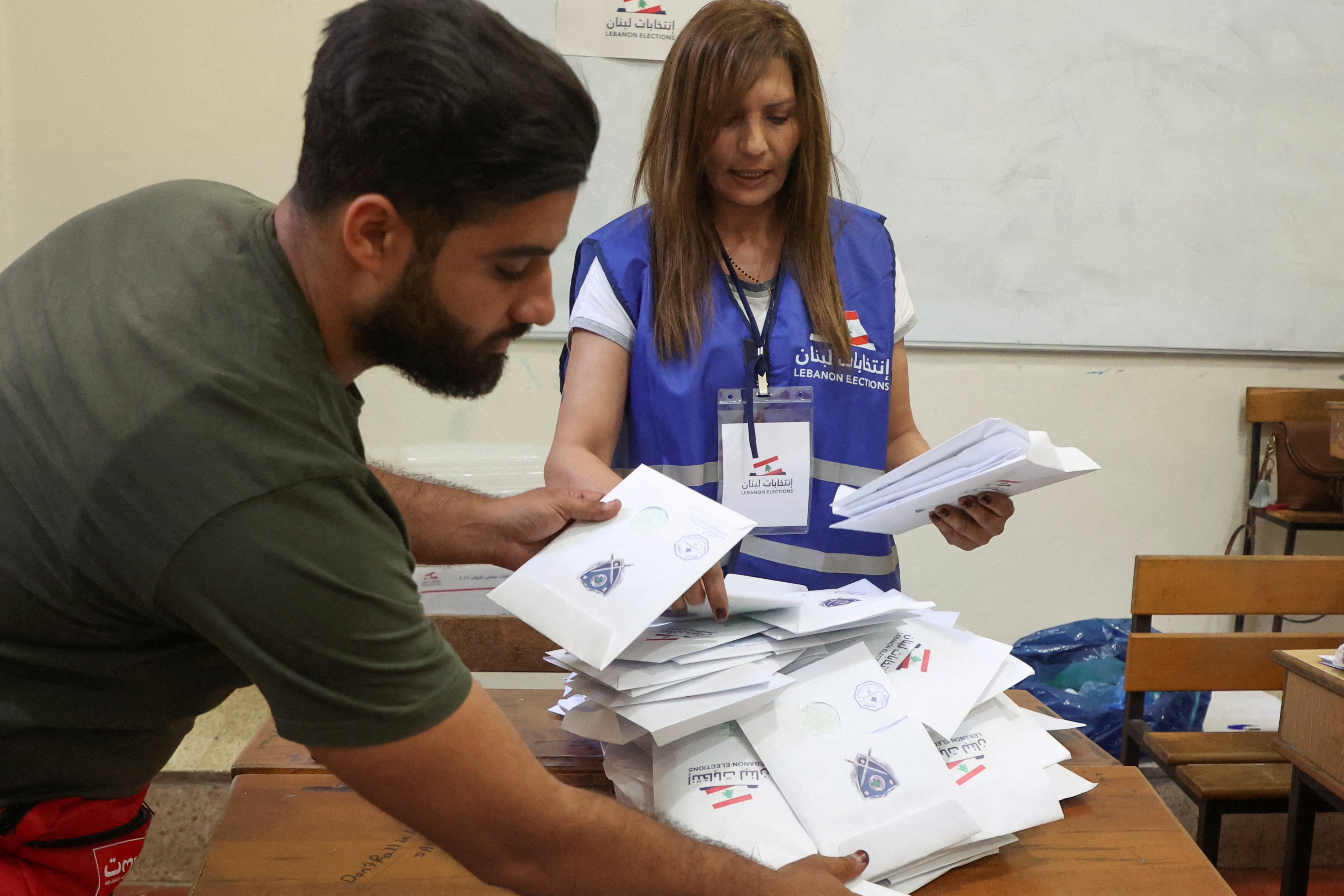 Electoral workers sort ballots after polls closed during Lebanon's parliamentary election in Beirut