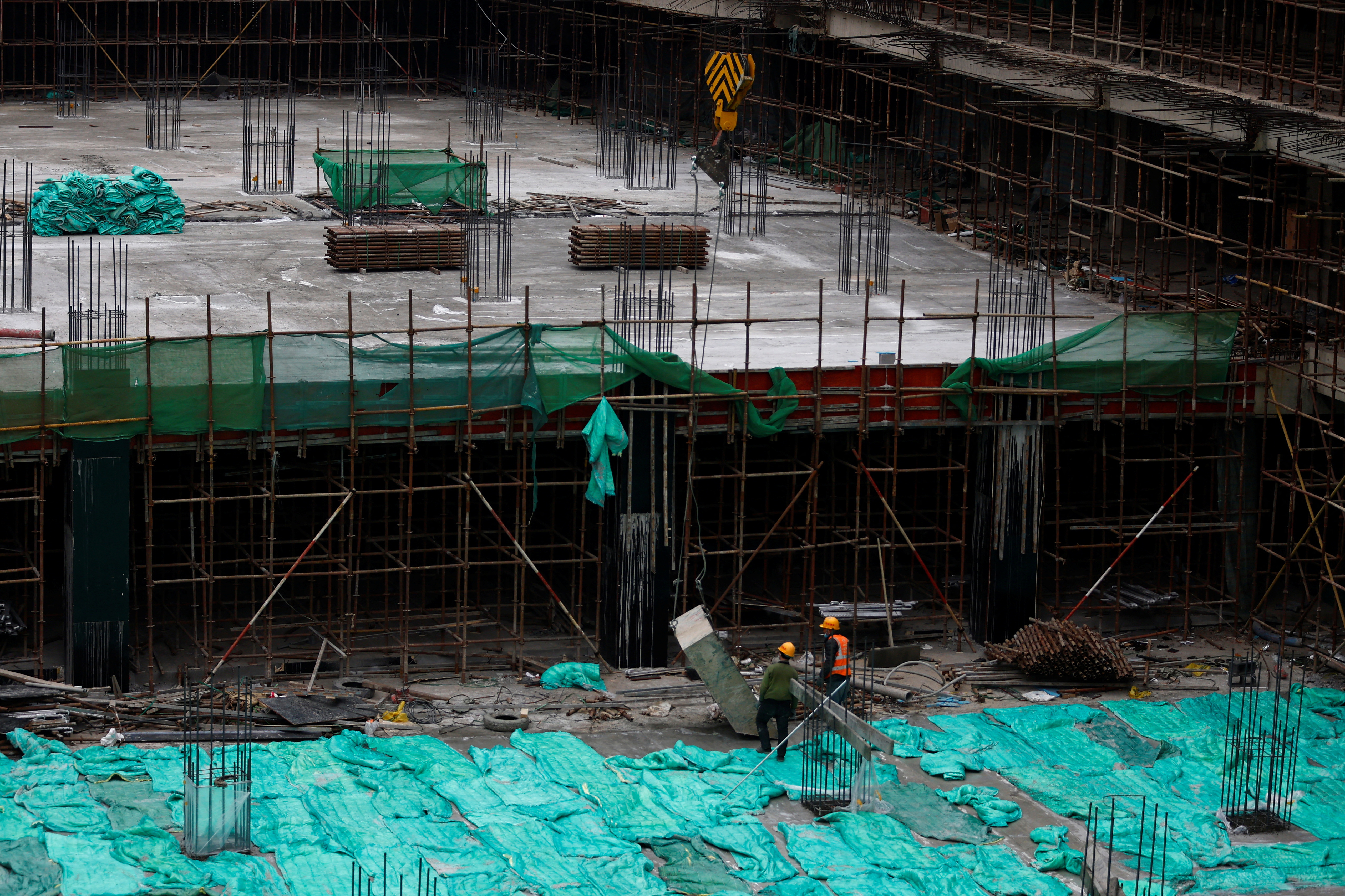 Workers work at a construction site in Beijing