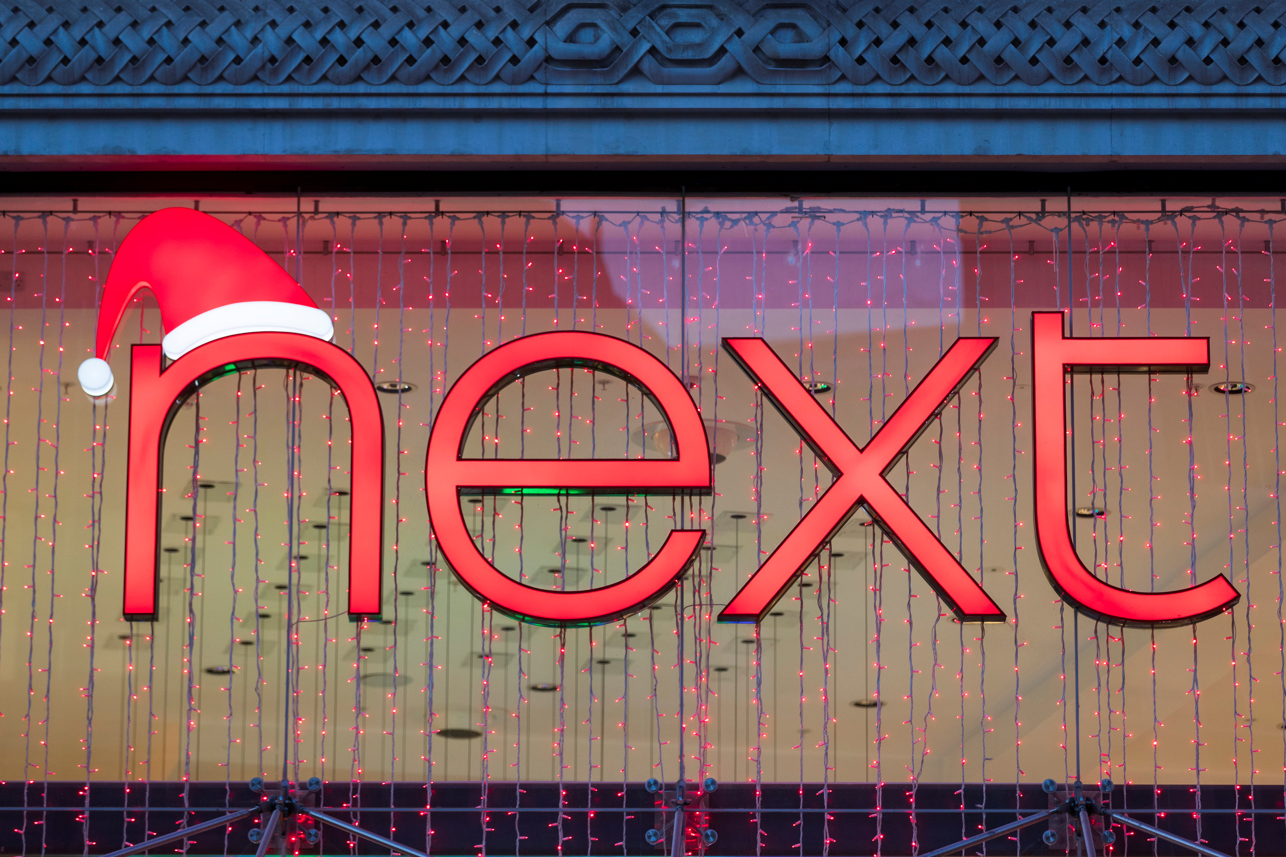 A Christmas themed logo of clothing retailer Next is seen at a store in London