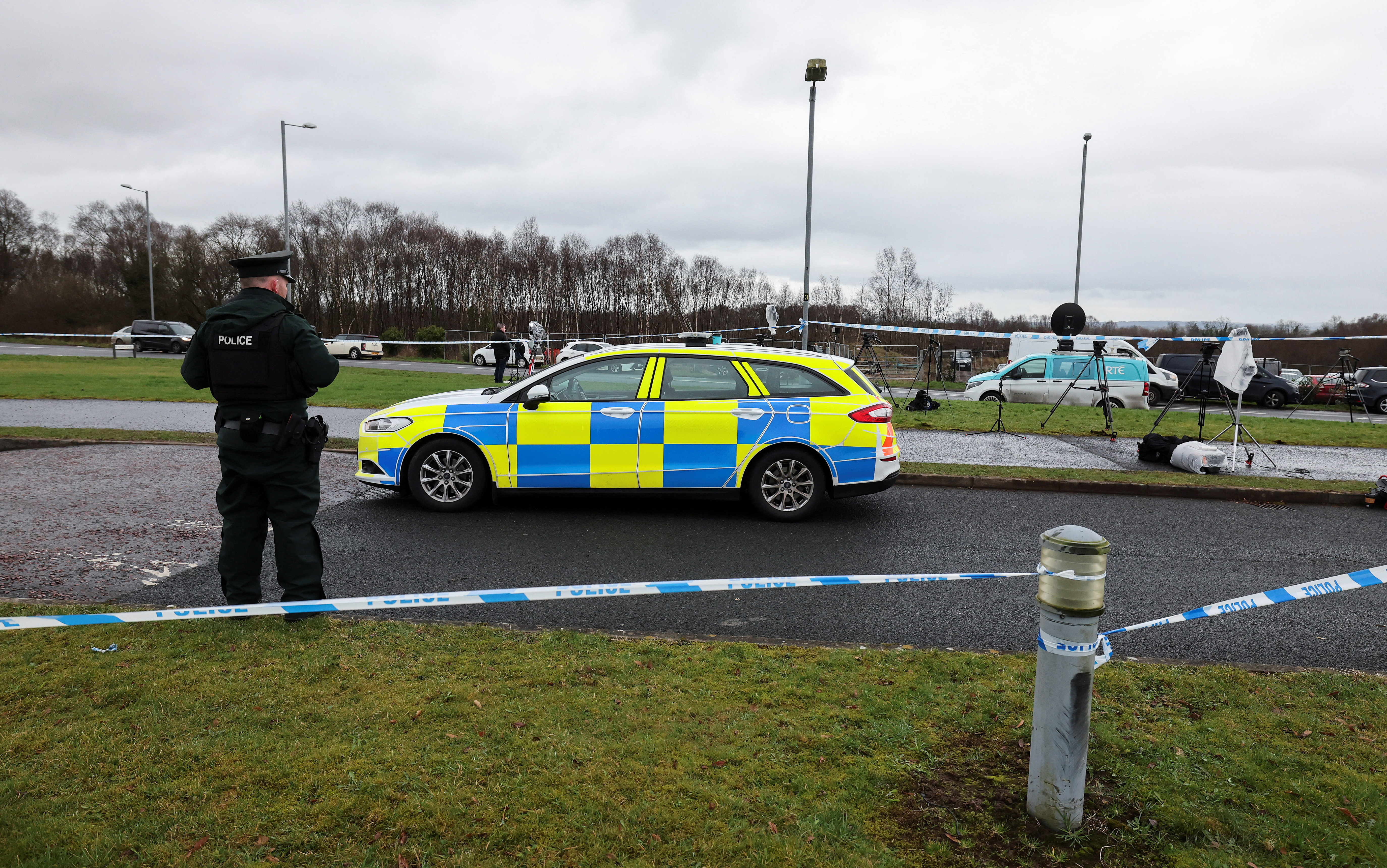 Police officer stands guard at the Youth Sport Omagh sports complex, where off-duty PSNI Detective Chief Inspector John Caldwell was shot.