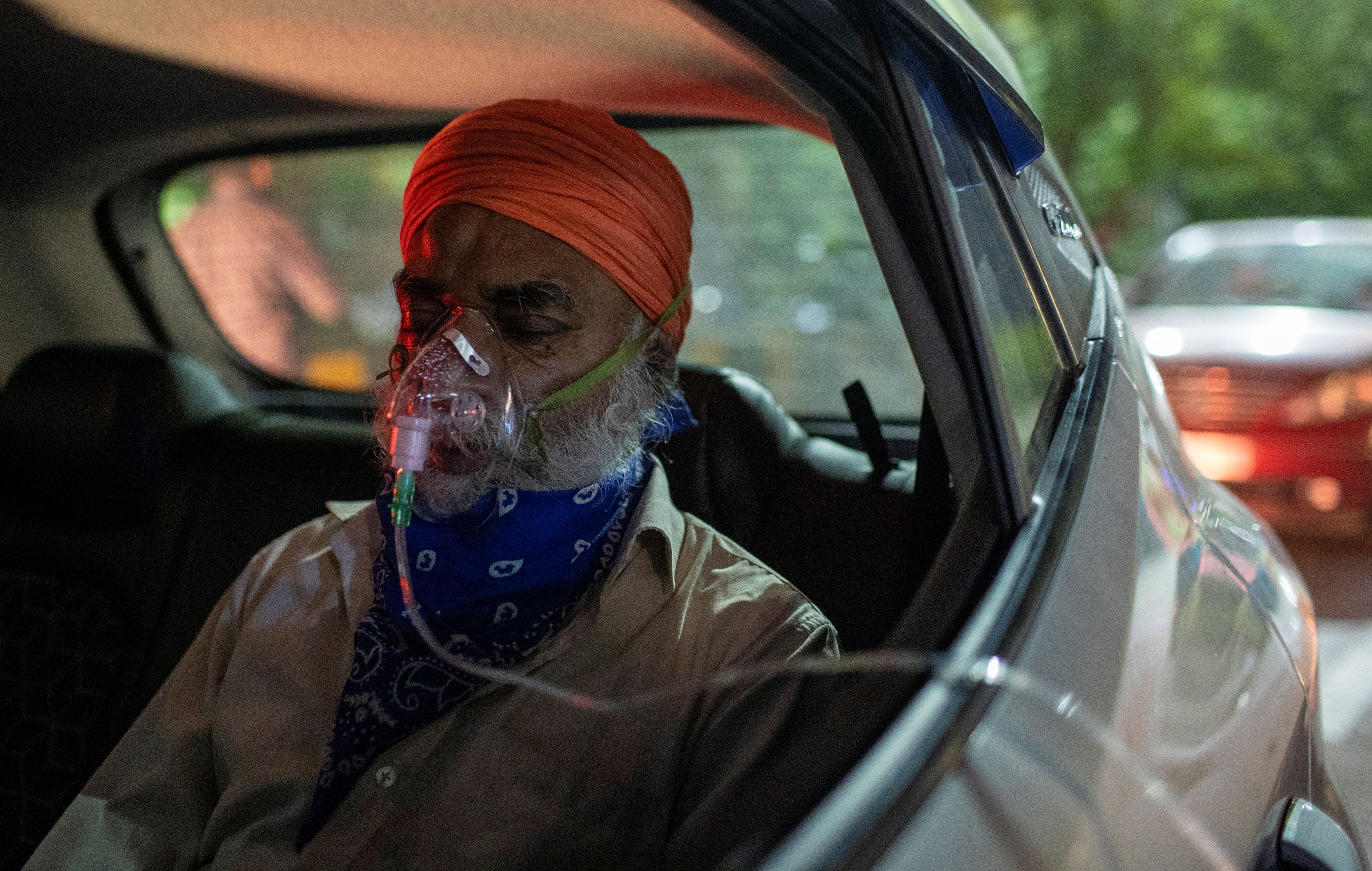 A man with a breathing problem receives oxygen support for free at a Gurudwara, in Ghaziabad