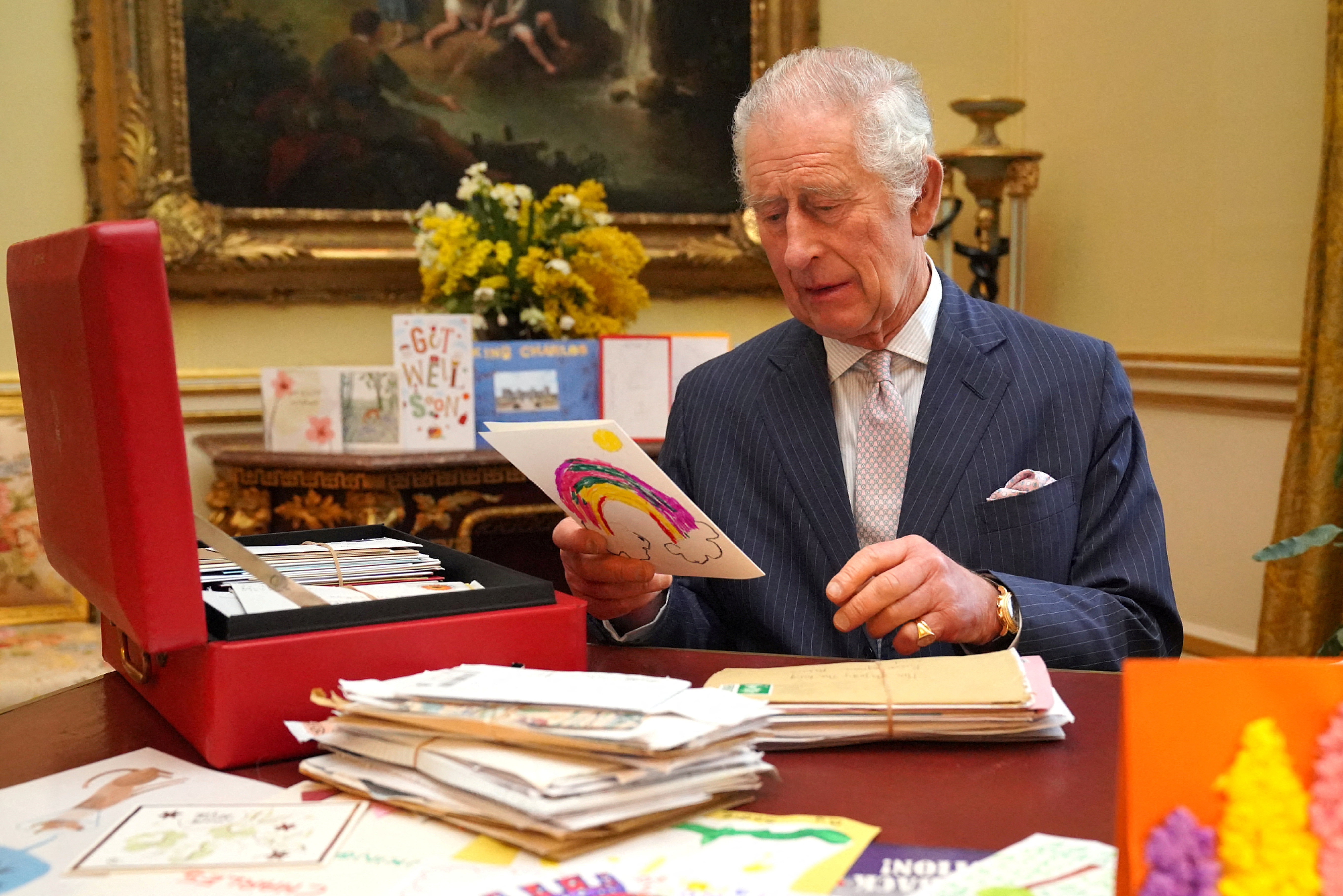 Britain's King Charles reads cards and message, in London