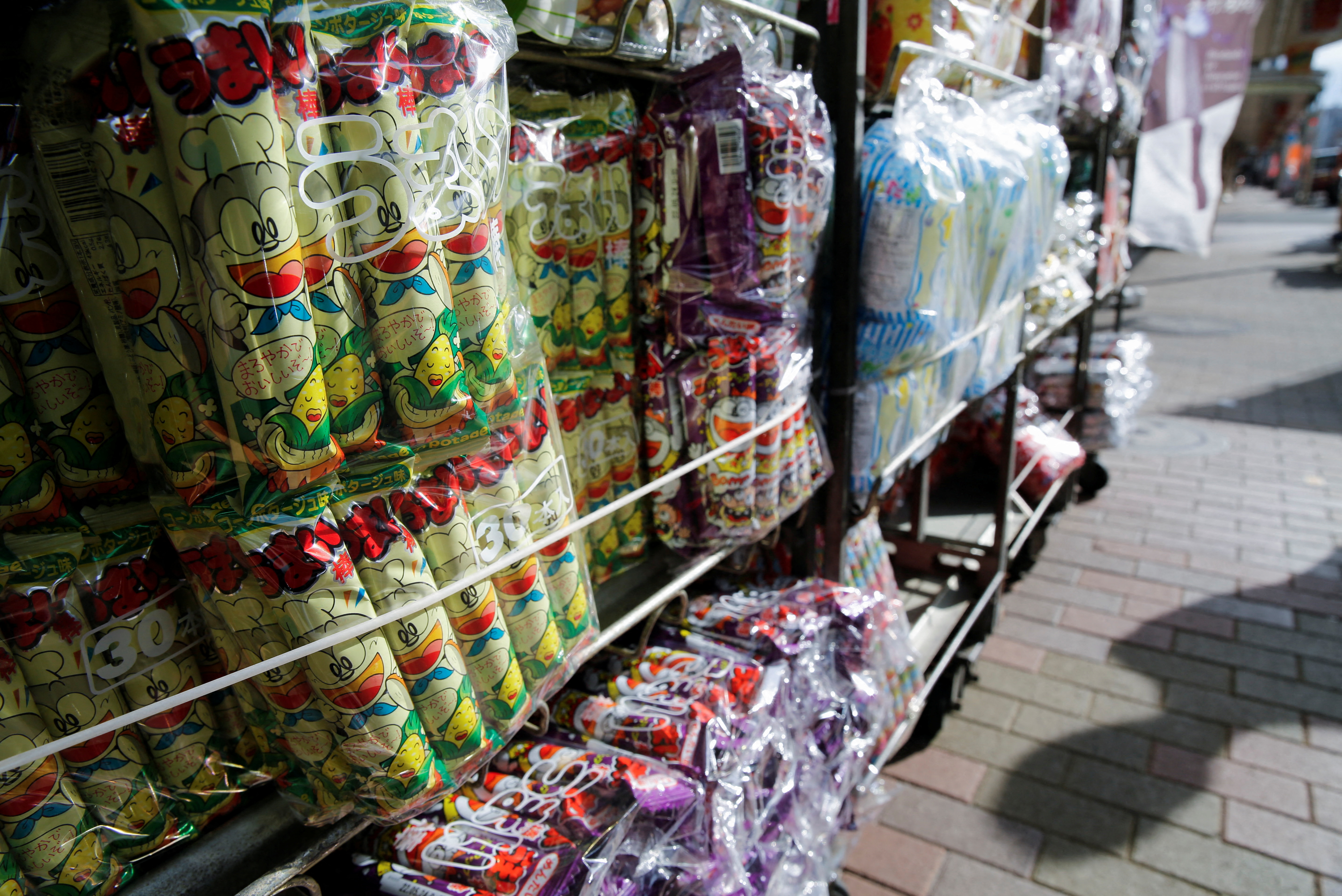 Several flavours of 'Umaibo', a popular Japanese corn snack, are displayed at a confectionery wholesaler's in Tokyo