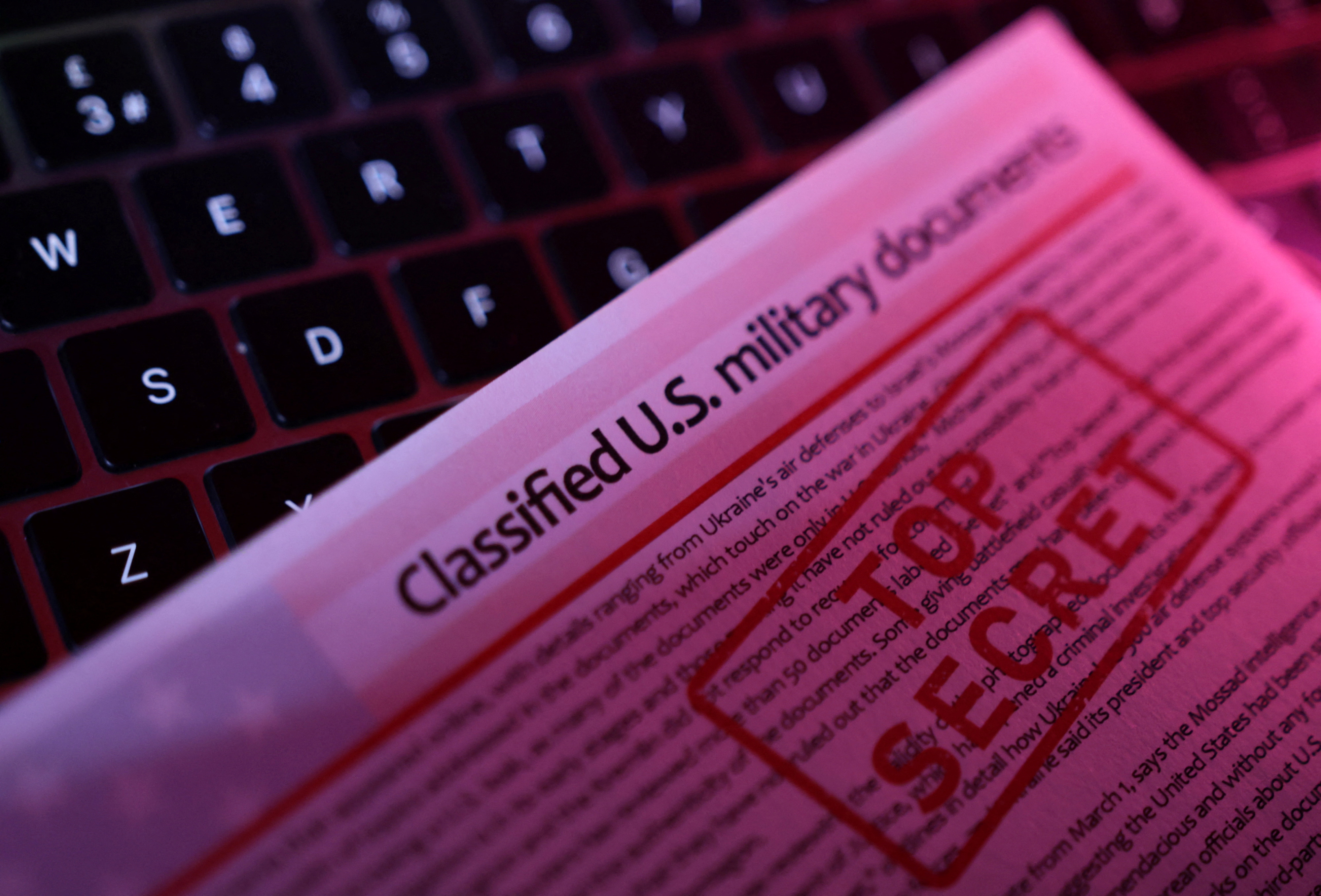 A mockup representation of classified U.S. military documents and a keyboard are seen in this illustration