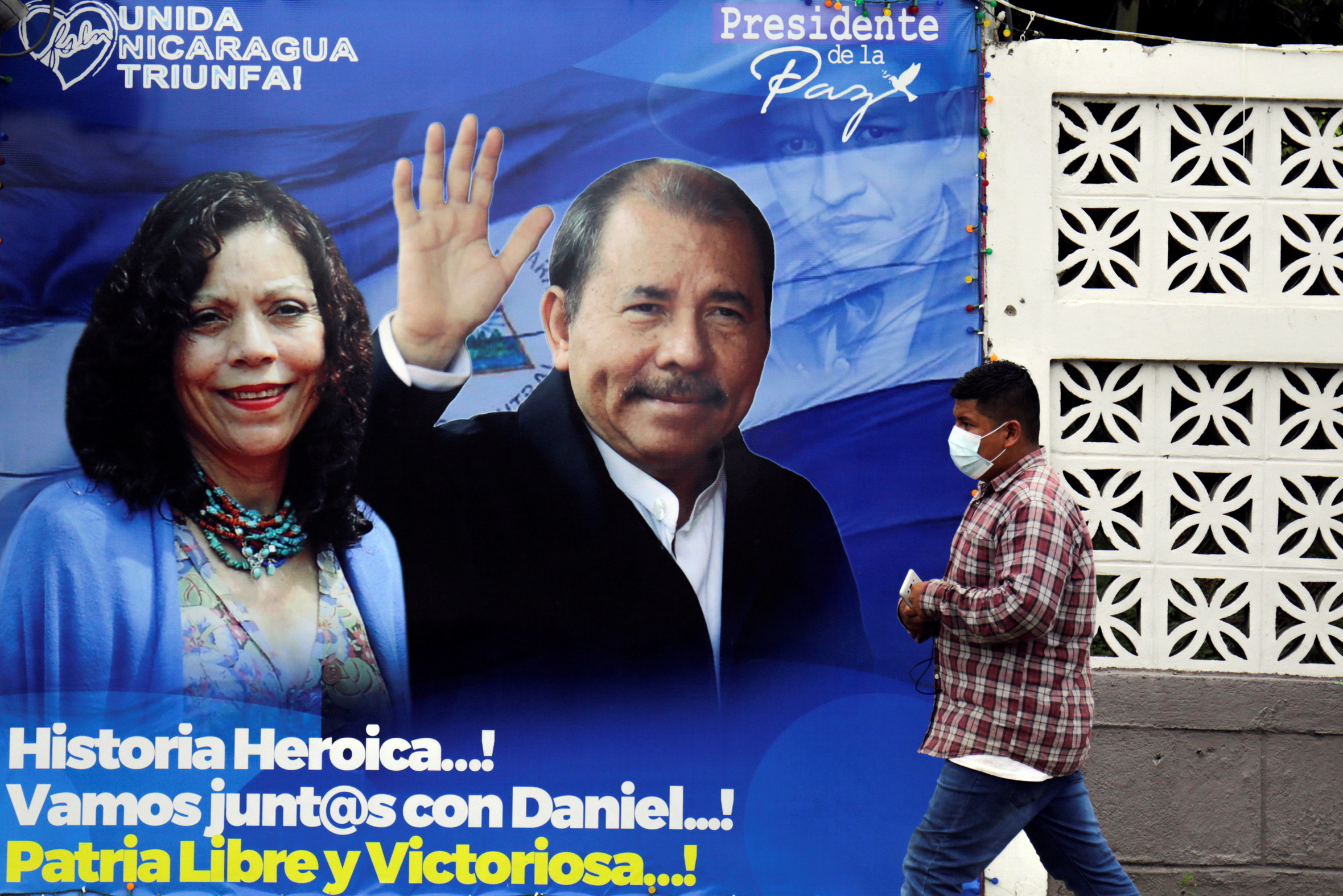 A man walks by a banner depicting Nicaragua's President Daniel Ortega and Vice President Rosario Murillo ahead of the country's presidential elections, in Managua, Nicaragua November 2, 2021. Picture taken November 2, 2021. REUTERS/Stringer NO RESALES. NO ARCHIVES