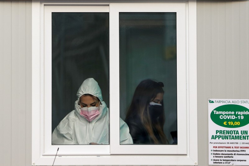 A medical staff is seen in a gazebo outside a pharmacy where rapid COVID-19 swab tests are carried out, in Rome