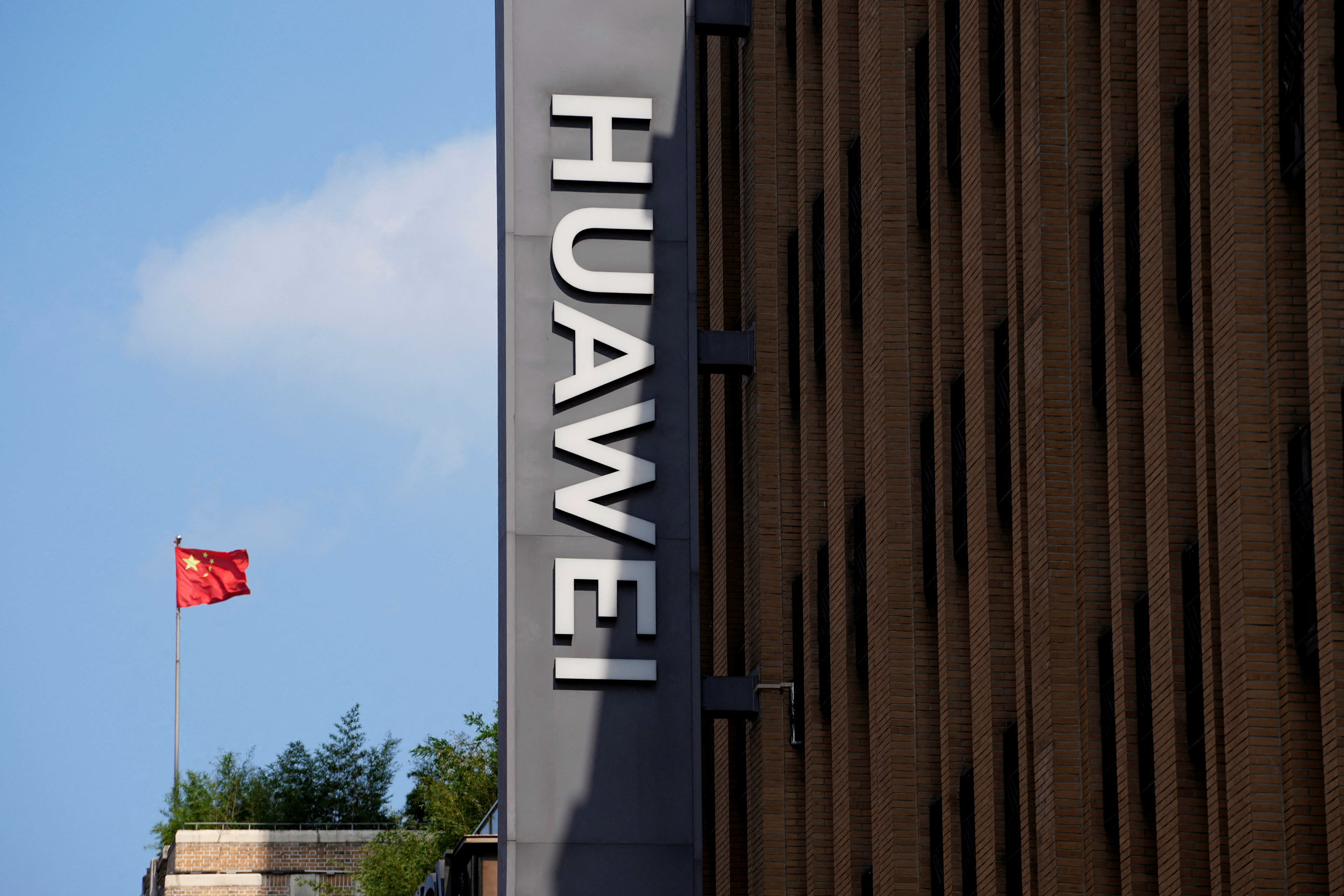 A Chinese flag flutters near a Huawei store in Shanghai