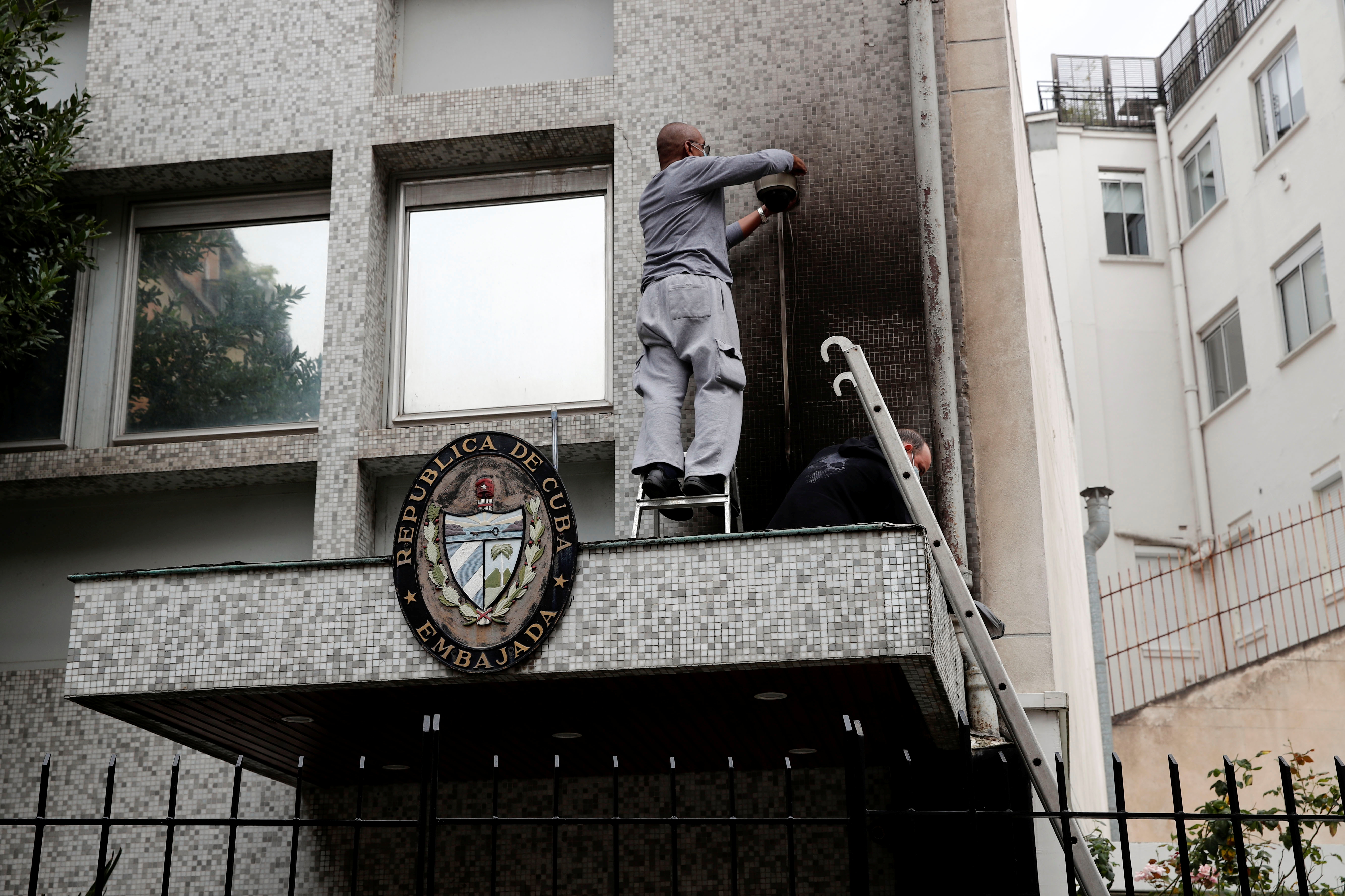 Experts inspect the damage at the Cuban embassy following an overnight petrol bomb attack on its building, in Paris, France July 27, 2021. REUTERS/Benoit Tessier