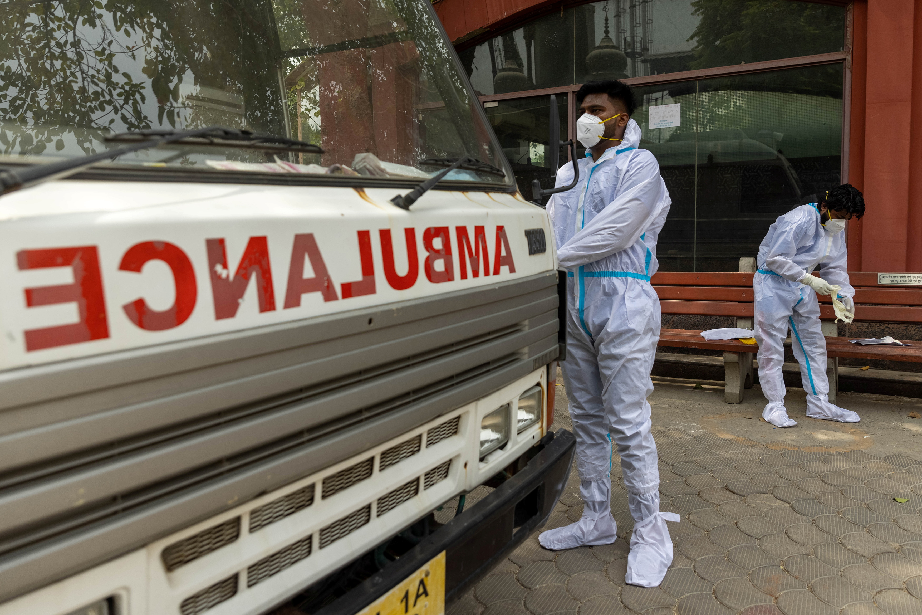 Health workers wear personal protective equipment (PPE) as they prepare to carry the body of a person, who died from complications related to the coronavirus disease (COVID-19), for cremation at a crematorium in New Delhi