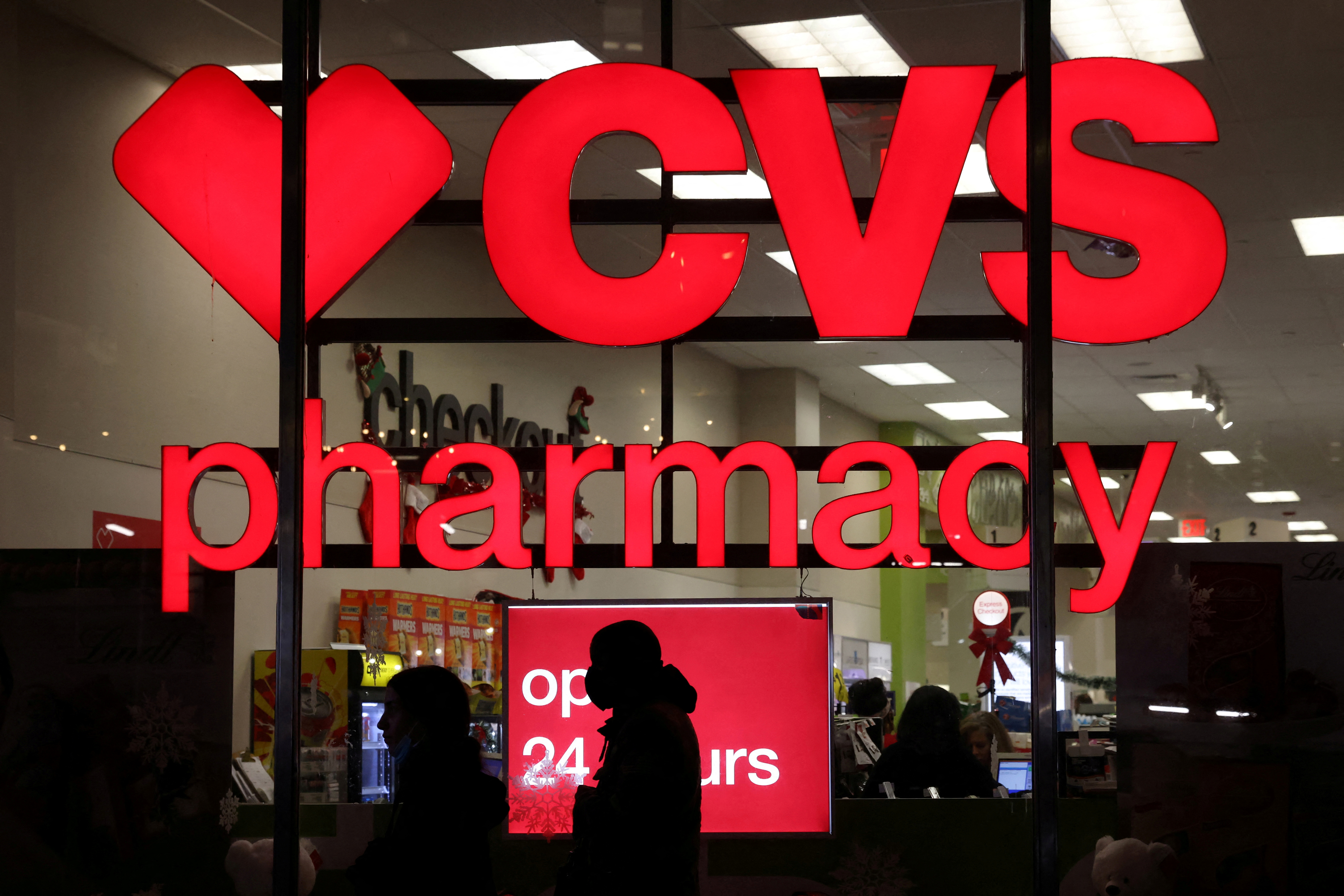 People walk by a CVS pharmacy store in Manhattan, New York City