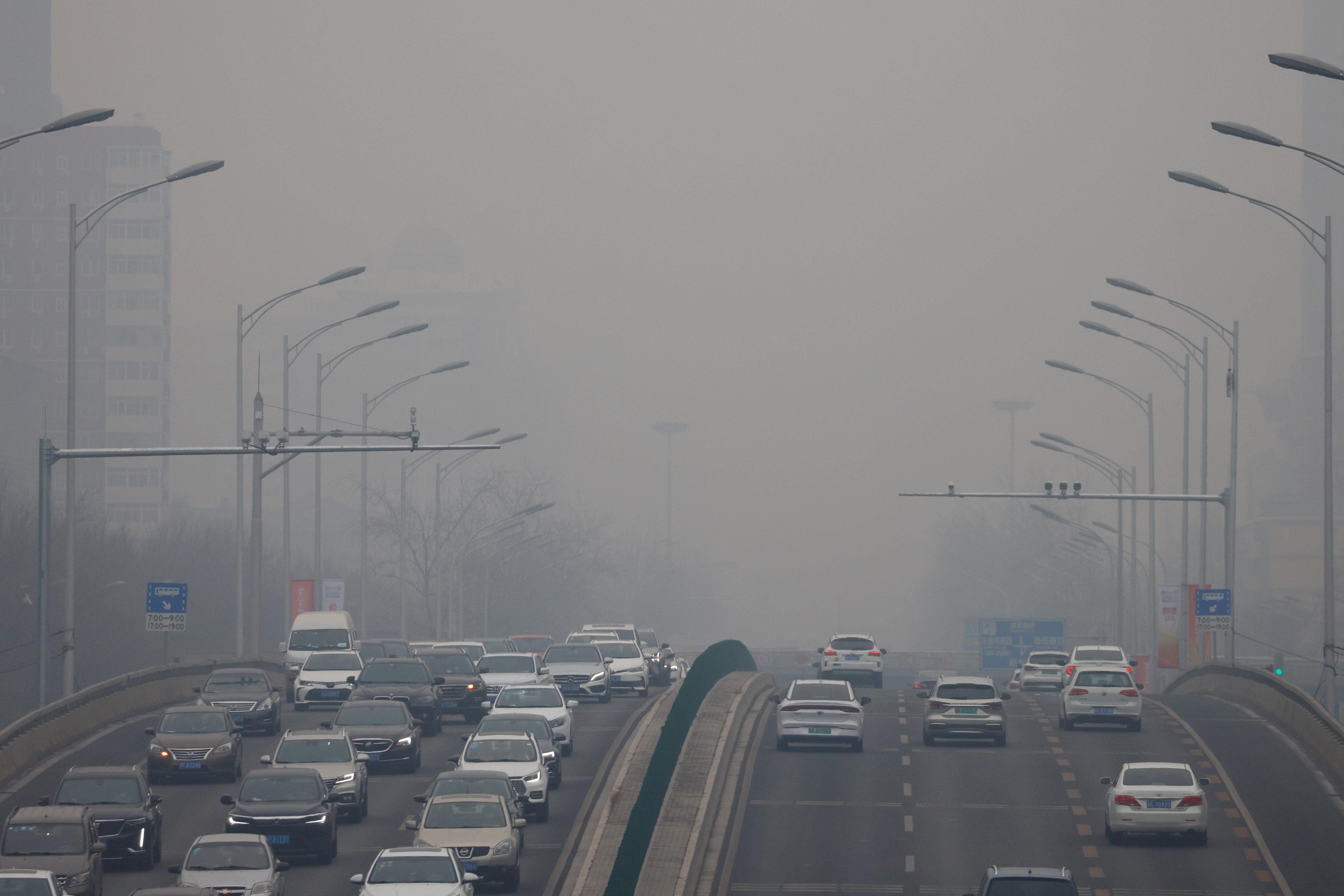 Cars move on a road during a day with polluted air, following the outbreak of the coronavirus disease (COVID-19), in Beijing, China February 13, 2021