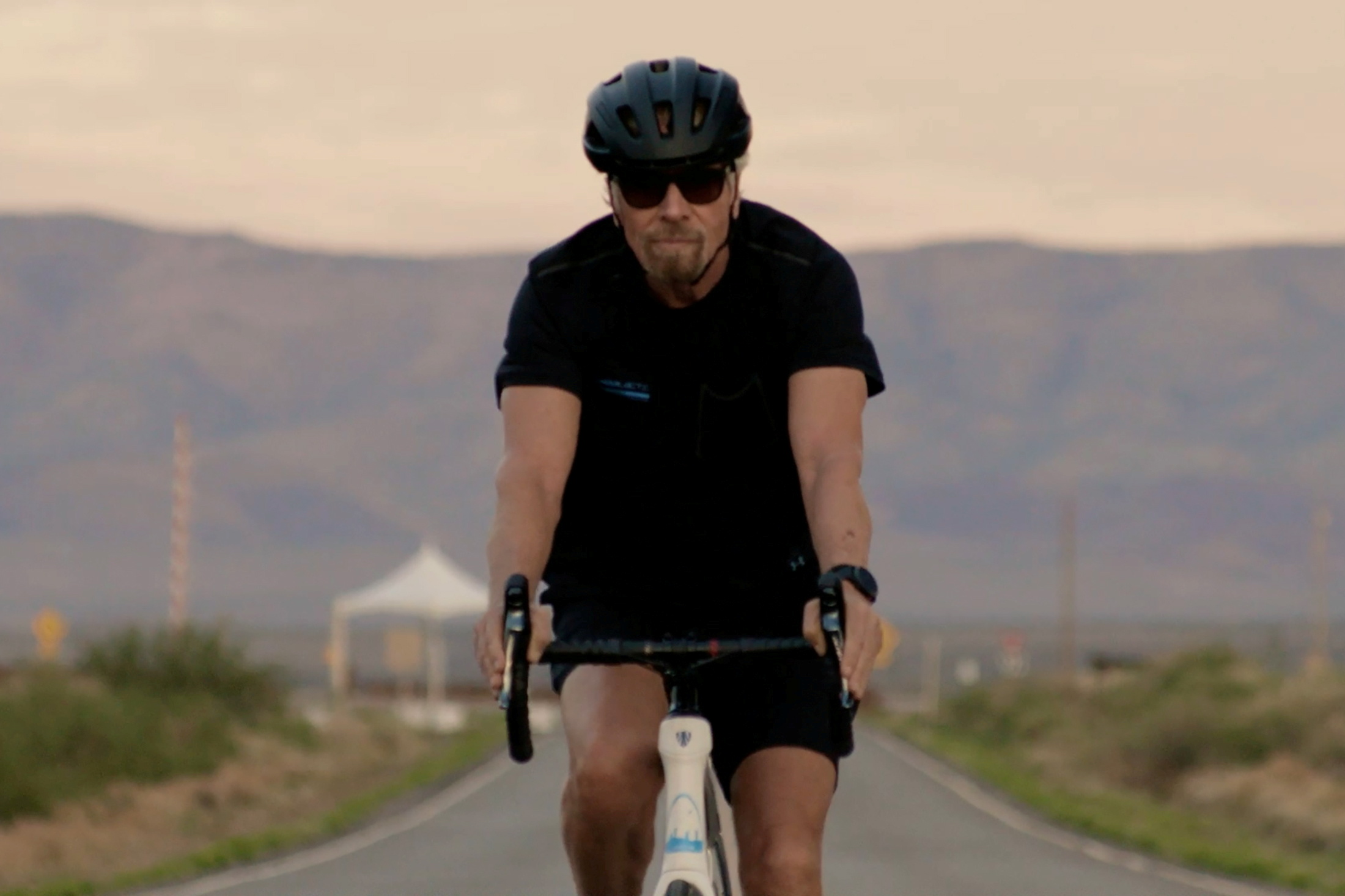Richard Branson arrives by bicycle to Spaceport America