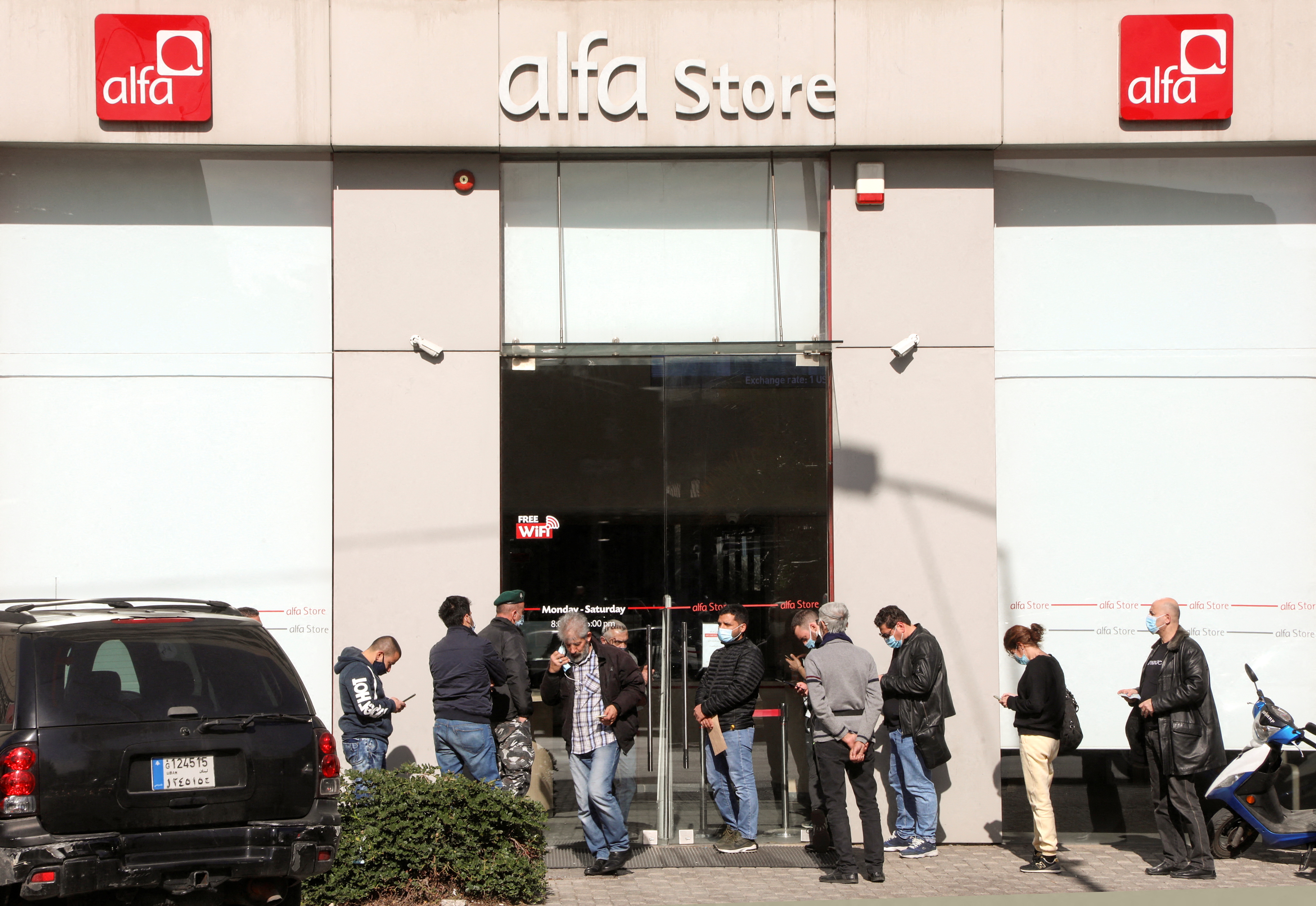 People queue outside an Alfa telecommunications store in Beirut
