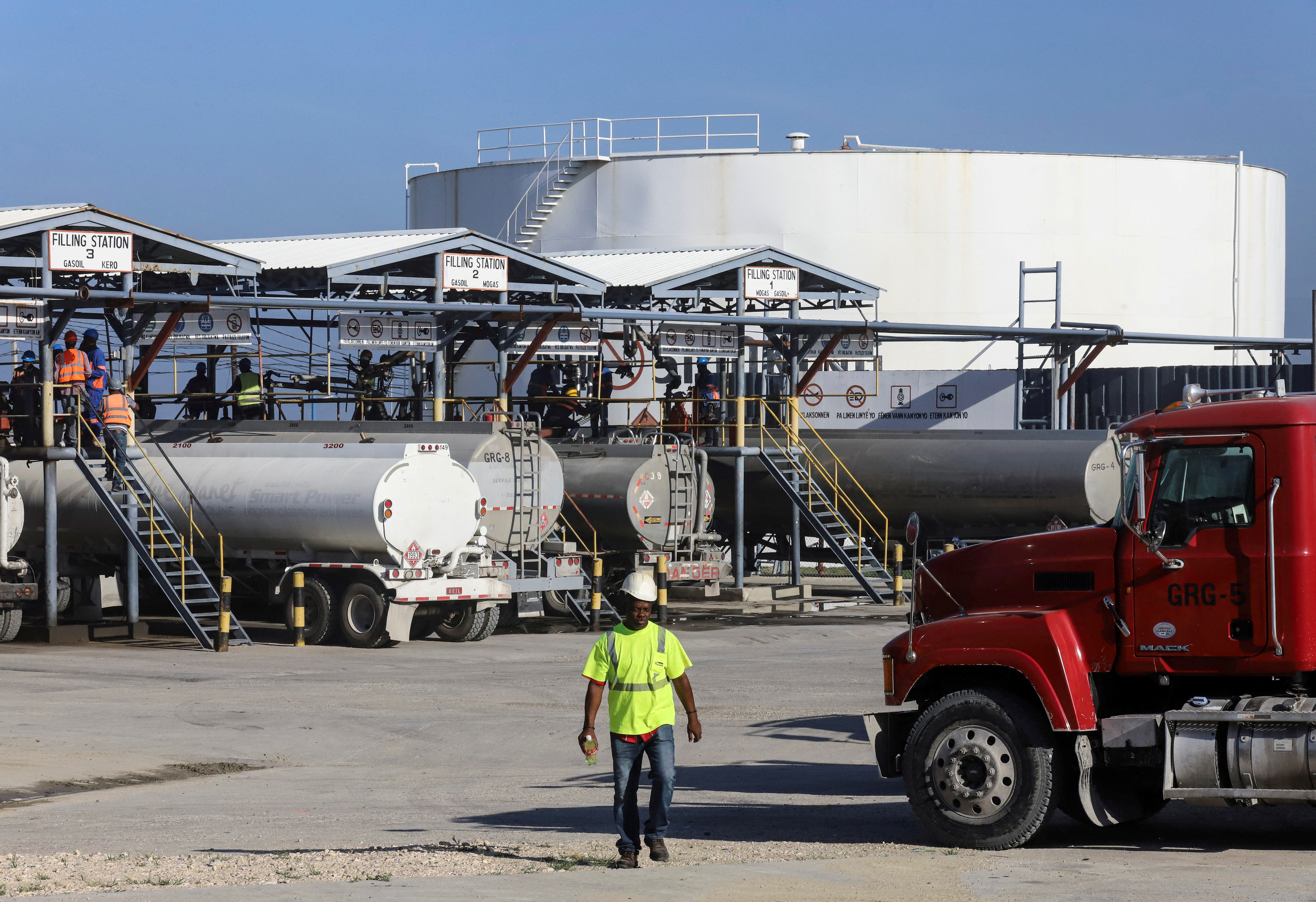Tanker trucks are being filled with fuel at the Varreux fuel terminal for distribution, in Port-au-Prince