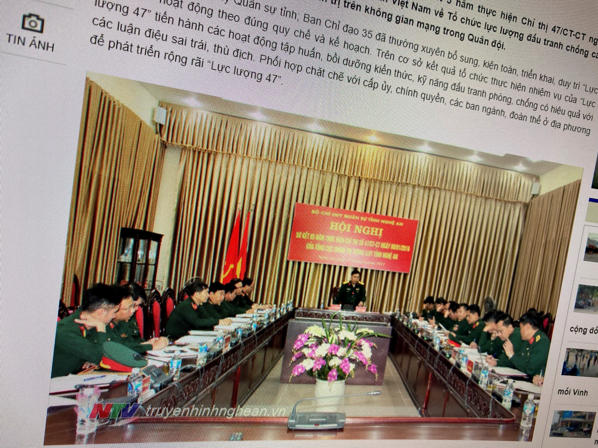 A state media article from March 17, 2021 with a picture of a meeting marking five years since the creation of Vietnam's 'Force 47' cyber army is displayed on screen in this picture takenJuly 8, 2021. TRUYENHINHNGHEAN.VN via REUTERS 