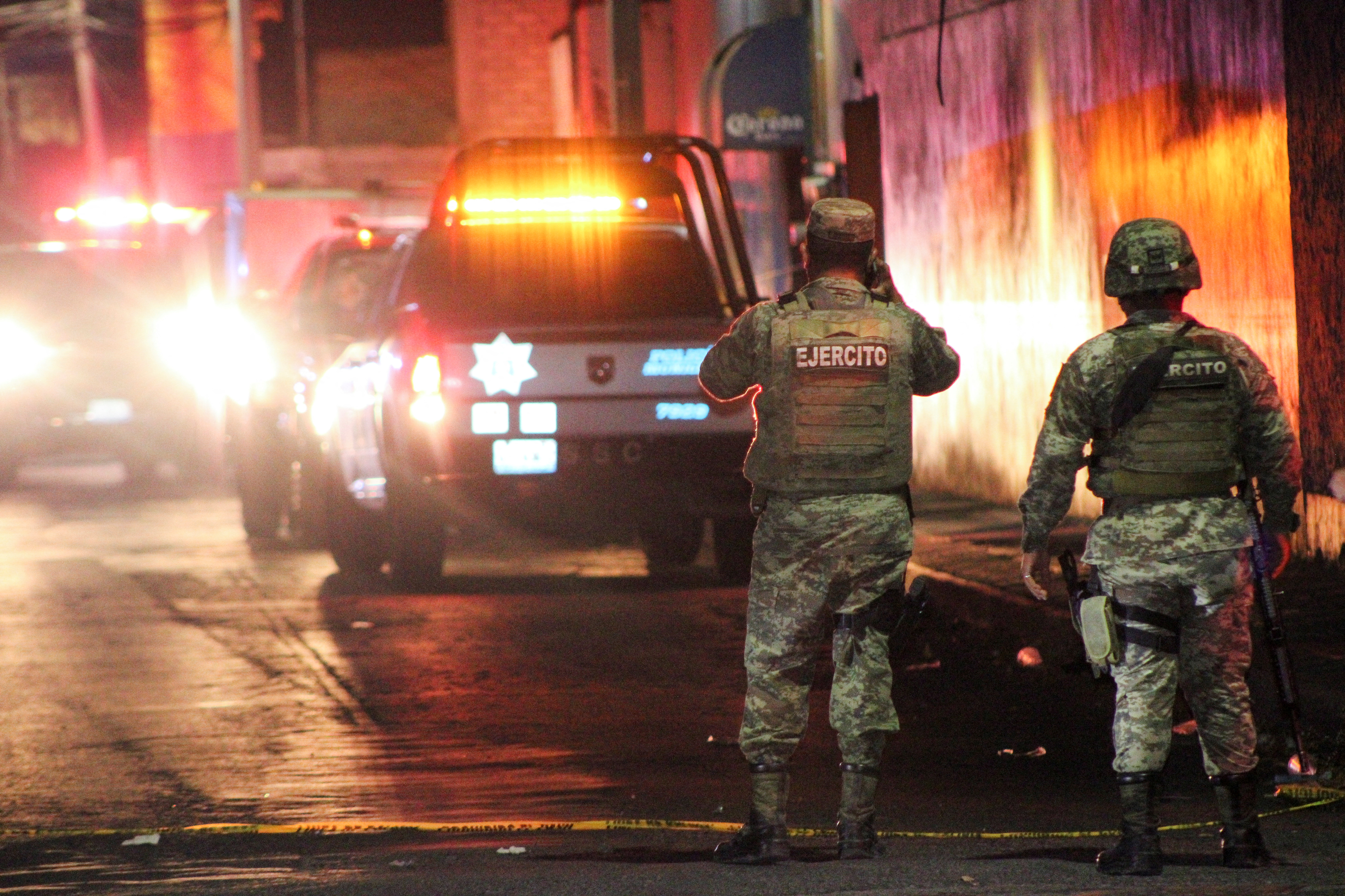 Security forces guard the scene where gunmen attacked bars and killed people, in Celaya
