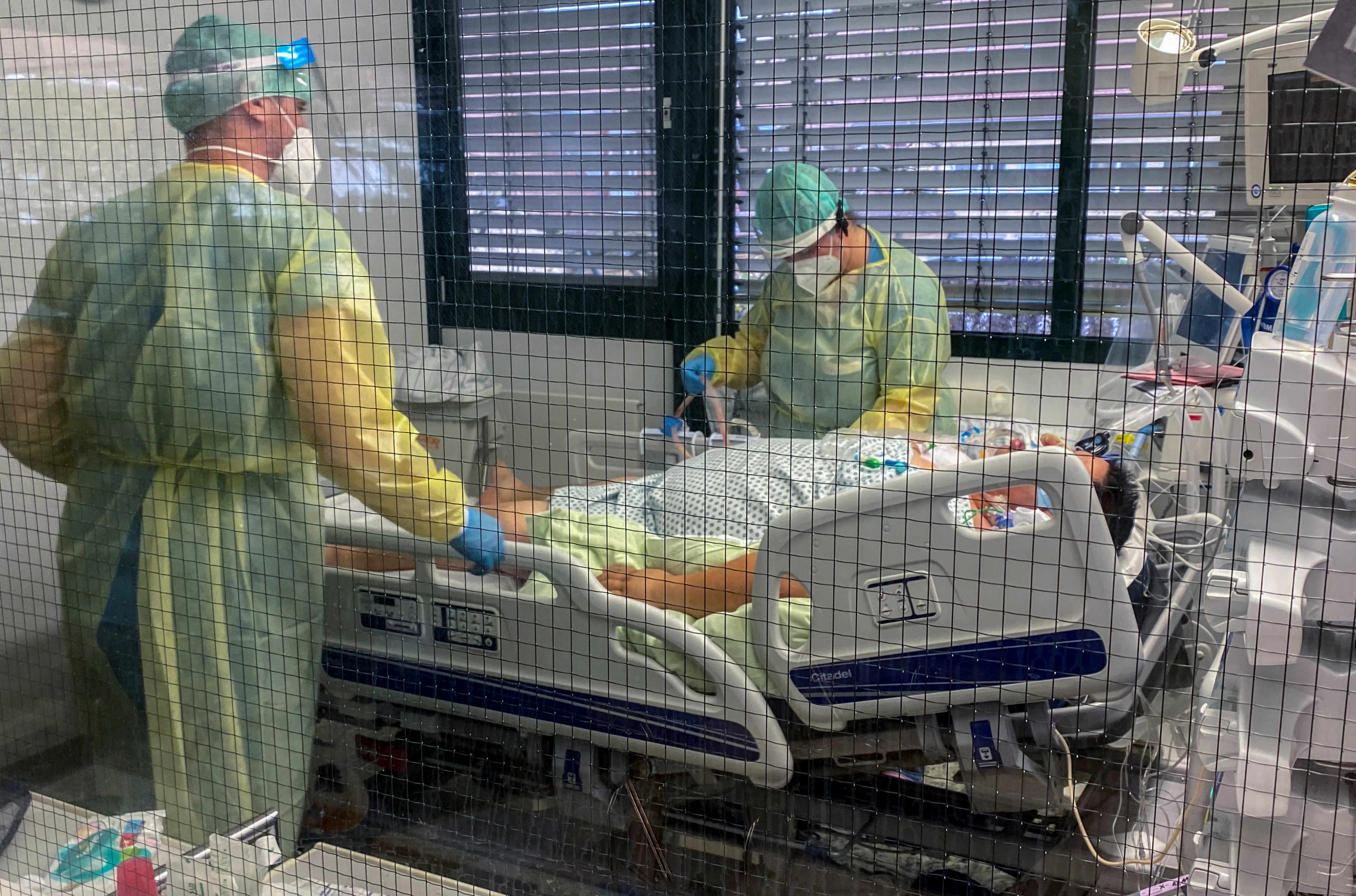 Medical staff members of Munchen Klinik Schwabing hospital take care of a patient infected with the coronavirus disease (COVID-19) in the intensive care unit in Munich