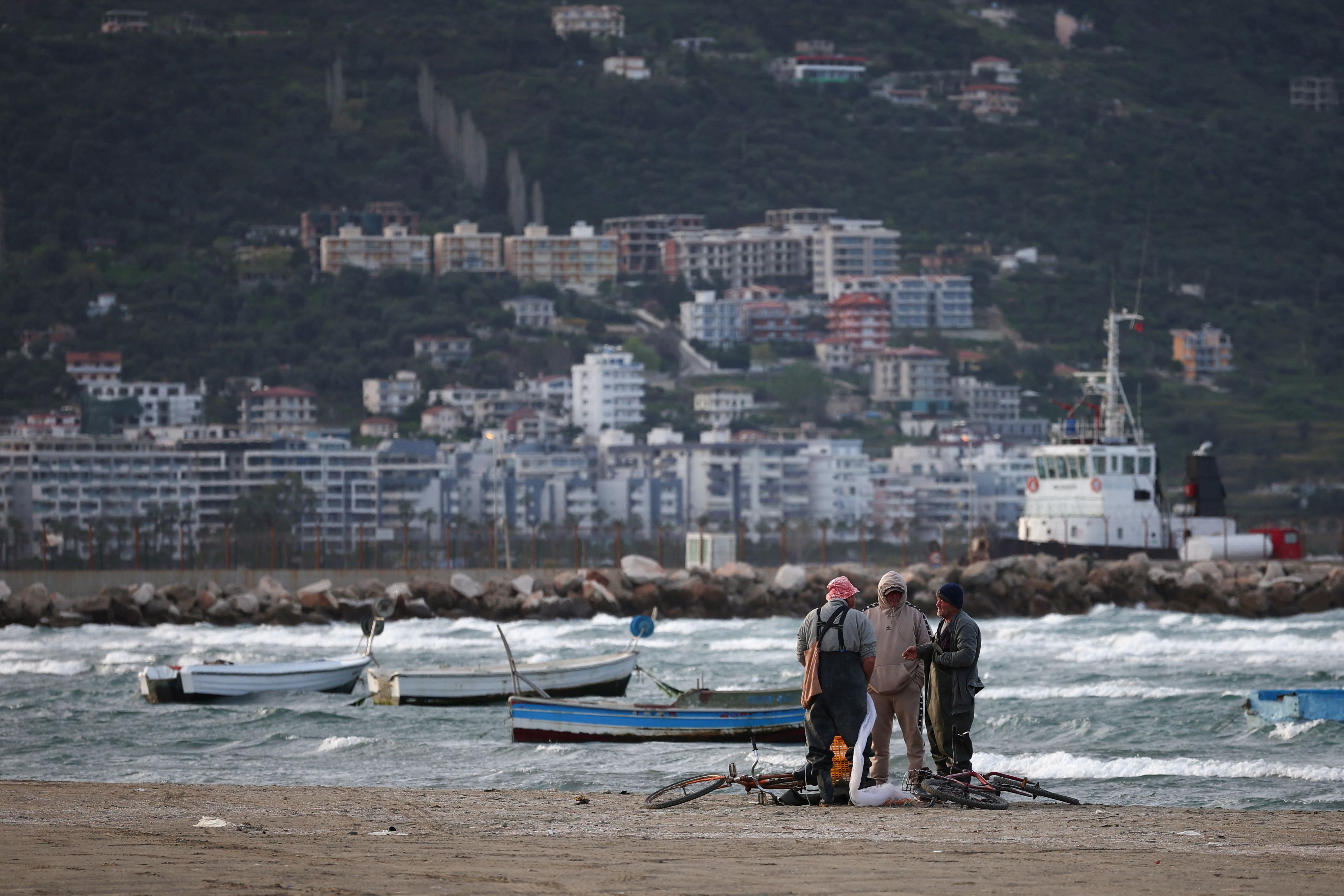 Fishermen stand by the sea in Vlora
